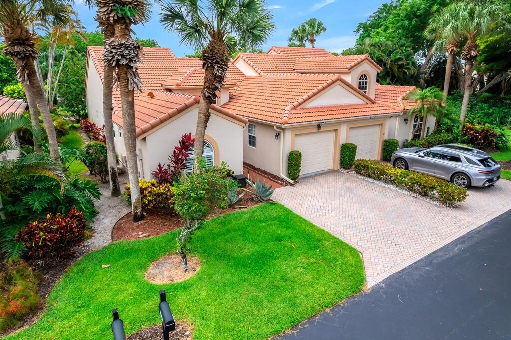 Enjoy the perfect blend of casual luxury and maintenance-free living in this beautifully renovated 2-bedroom plus den villa located in a sought-after gated community. Overlooking serene lake views, this light-filled home features a spacious split-bedroom floor plan, two dining areas, an oversized primary suite, and an enclosed sunroom ideal for relaxing or entertaining. INTERIOR HIGHLIGHTS include wood-look plank tile flooring, plantation shutters, impact glass windows, updated bathrooms with designer finishes, and a glass-enclosed patio. EXTERIOR FEATURES include a brand-new roof (2024), private patio with water views, and three dedicated parking spaces. Located directly across from the clubhouse, enjoy resort-style amenities including pickleball, tennis, a pool, fitness center,  social events, and live entertainment. The association fee covers building insurance, roof maintenance, lawn care, water, cable, and security for worry-free living. Schedule your private showing today!
