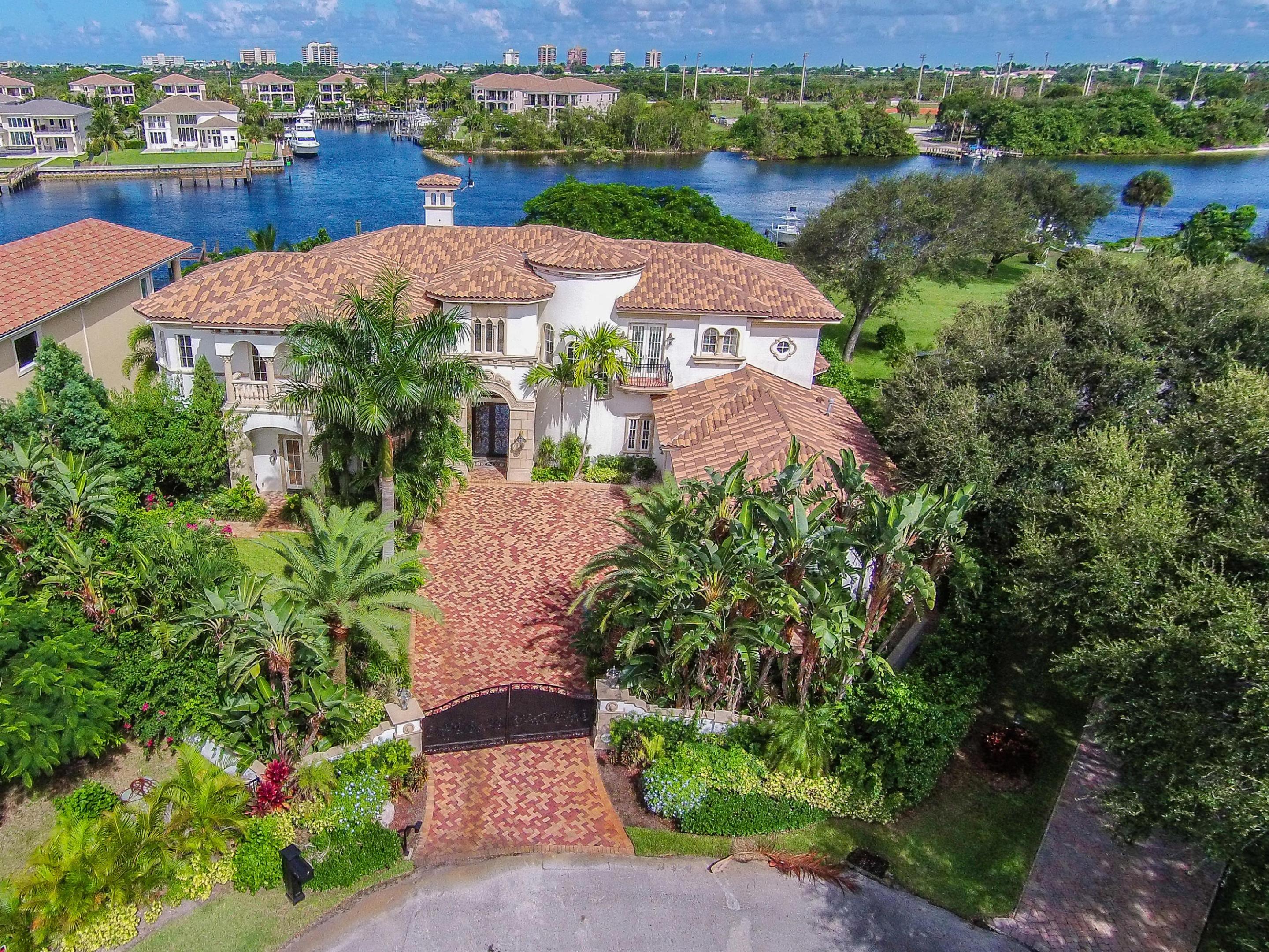 Stunning waterfront custom built home with all high end finishes throughout. 116' of water frontage in a no-wake zone with the dock capacity to hold over 100' yacht. This gated enclave is truly a masterpiece, with no detail overlooked. From the double crown molding to the mahogany baseboards this home is a work of art. Imported floors from spain, hand crafted custom doors from Central America, each finish has a story behind it. Chefs Kitchen with 2 fridges, 2 sinks, 2 ovens, 2 dishwashers, granite counter tops, and designer cabinets.
Master bedroom with views of the intracoastal, separate his and hers bathrooms as well as closets with custom built ins. The home boasts 5 bedrooms, plus an office/den, game room, and a theater room. Outdoor covered kitchen area with views of the interior and water. Impact doors and glass throughout the home. The home was built in 2006, less than 10 years old! Breathtaking living room with 20+ ft high ceilings and an ornate tailor-made fireplace. Brazilian ipe wood in "his" shower, cherry wood and mahogany if found throughout the residence (even in the elevator!). Lush landscaping, an immaculately cared for lawn, with several fruit trees on over 1/2 acre. Security cameras placed in the interior and exterior of the home, along with a gated entry.