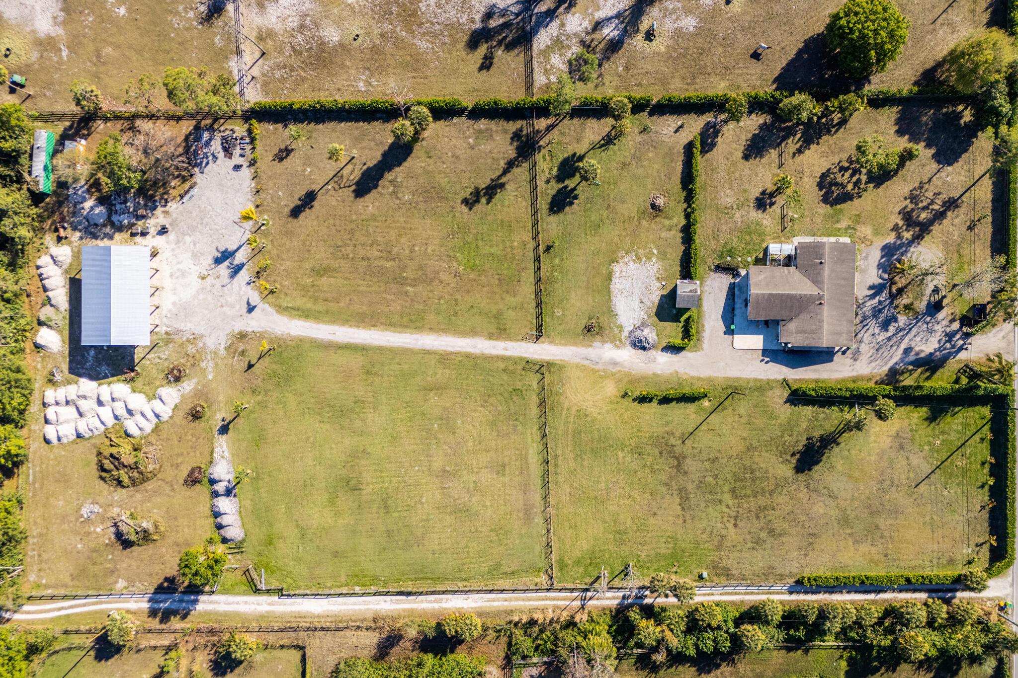 Exceptional multi-income equestrian investment opportunity south of Okeechobee Blvd. This cleared, fully usable property allows you to develop a premier horse facility while generating immediate cash flow. The residence is converted into four income-producing units, currently bringing in $6,000+ per month. Ideal for barns, arena, paddocks, boarding, or agricultural use. A 40' x 60' pole barn offers conversion potential, and an RV hookup adds flexibility. Major upgrades include a newer water system and updated septic. Build out a barn and equestrian setup for an additional $10,000+ monthly income potential. Rare combination of income, land, and upside in a prime location.