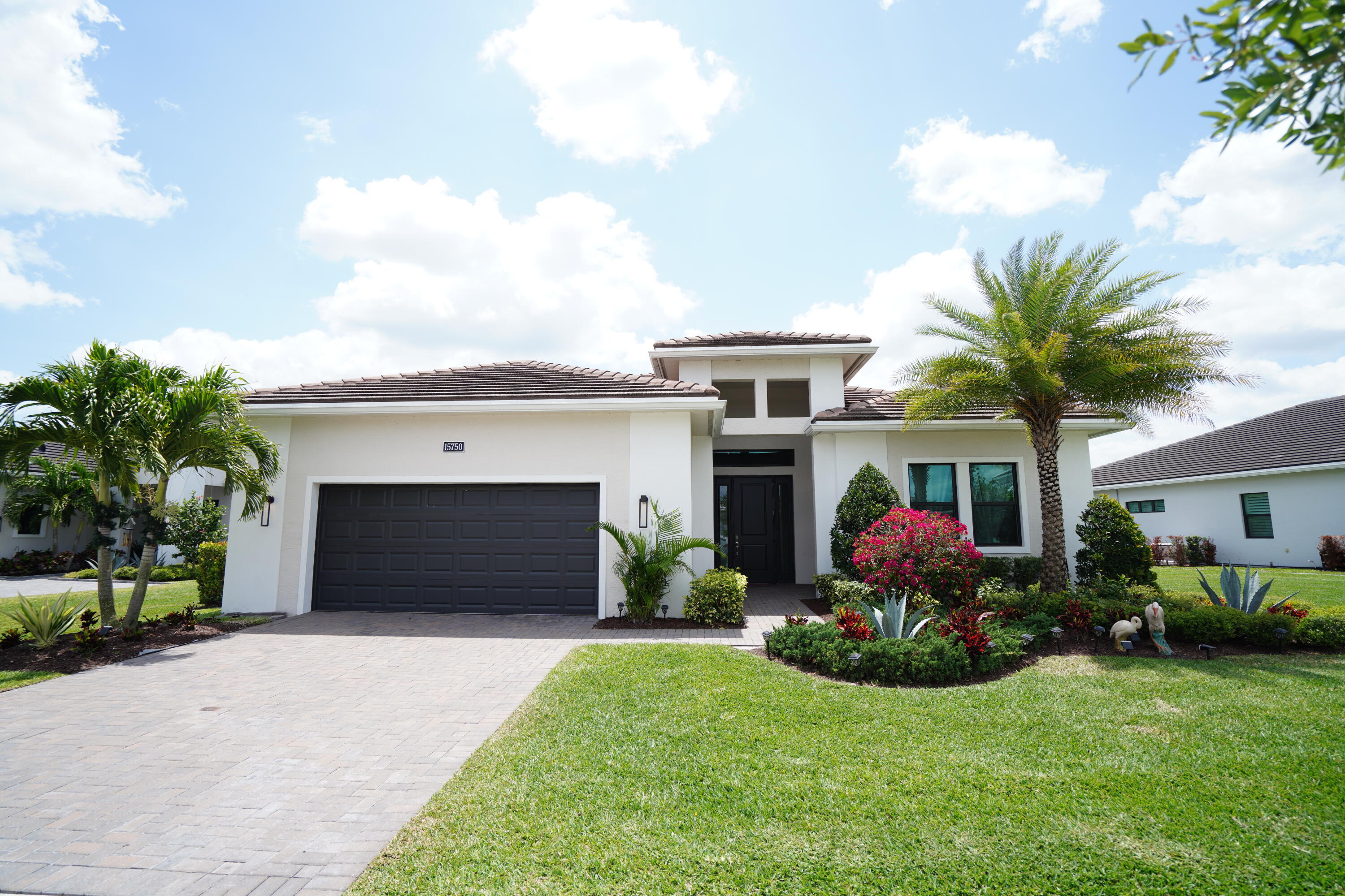 LUXURY LAKEFRONT LIVING IN PREMIER 55+ GATED COMMUNITY!    Welcome to this exceptional, move-in ready Lake Vilano model in the highly desirable Cresswind community—offering the largest and most sought-after 3BR + LARGE DEN / 3BA floor plan with breathtaking lake views. From the moment you enter, you'll be impressed by soaring ceilings, 8' doors, elegant wall accents, and stunning high-gloss Calacatta porcelain tile flooring, creating a sleek, modern feel throughout the main living areas.  Designed for Comfort & Flexibility: Spacious open-concept layout perfect for entertaining Split floor plan with two en-suite bedrooms for added privacy, Versatile DEN ideal for office, guest space, or hobby room, carpeting in all bedrooms.  This home offers 3,066 sq ft under air and 3,956 sq ft total. Chef's Dream Kitchen: Featuring custom white & dark gray cabinetry, sleek black countertops, gas cooktop, GE appliances, and a large center island with breakfast bar—perfect for everyday living and hosting. Private Owner's Retreat: Enjoy a serene escape with tray ceiling, oversized windows, lake views, dual vanities, and a massive walk-in closet (14x10). Outdoor Living at Its Finest: Relax or entertain on the elevated screened-in patio overlooking the lake, complete with a built-in summer kitchen—perfect for enjoying Florida's year-round sunshine. Bonus Upgrade: Whole-house water filtration system for purified water throughout. Resort-Style 55+ Living: Cresswind offers a vibrant lifestyle with a clubhouse, resort-style pool & spa, resistance pool, pickleball & tennis courts, bocce, walking trails, dog park, and a cutting-edge SmartFit Training Center with EGYM technology. A full-time Lifestyle Director ensures a calendar full of social events and activities. Residents also enjoy access to Westlake Adventure Park with additional resort-style amenities and sports courts.   This is more than a home—it's a lifestyle.   Schedule your private showing today—lakefront homes like this go fast!