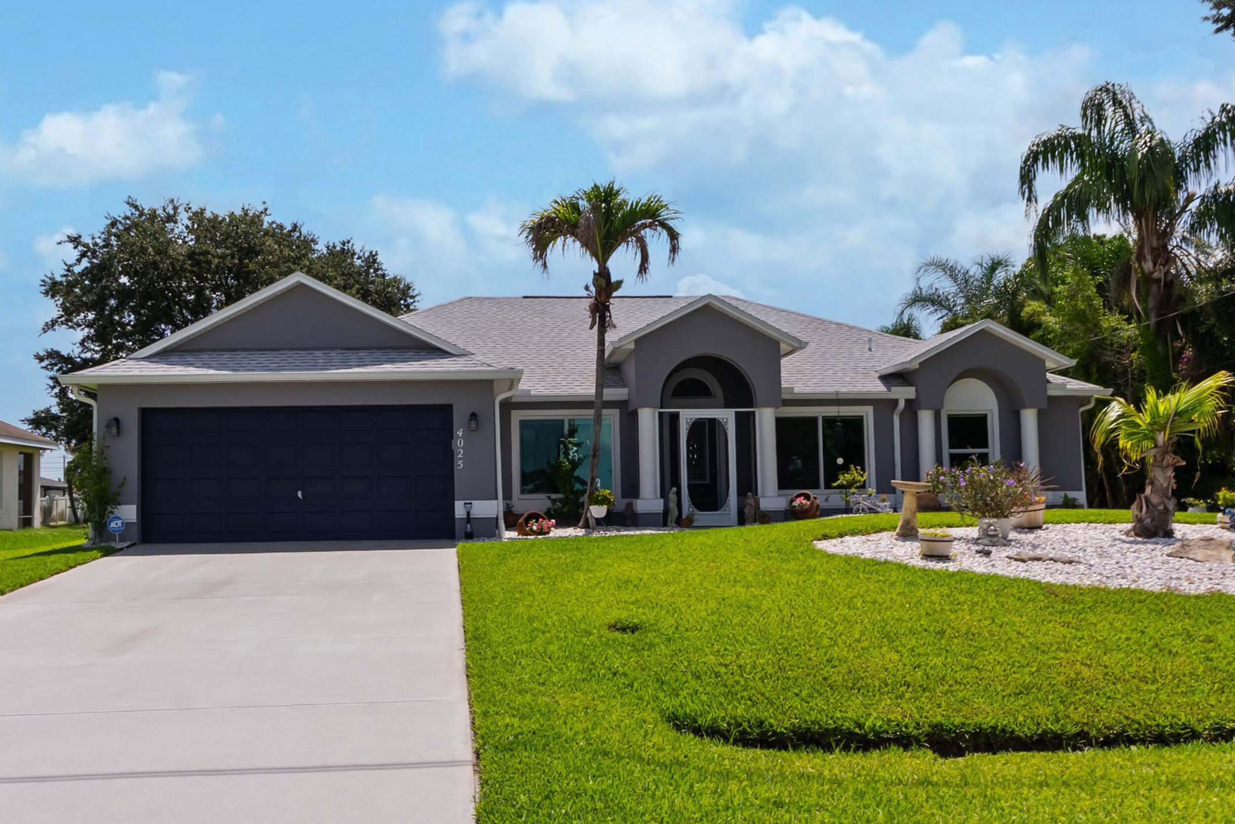 Pride of ownership shines through in this 3BD/2BA/2CG home! The heart of this house is the blended kitchen & living room, perfect for your living & entertaining needs, while the formal dining room & den offer flexible space for large gatherings & a home office. The large primary suite features a soaking tub, dual sinks & a newer seamless glass shower enclosure. Freshly painted interior & exterior, LVP flooring in bedrooms, premium granite counters & stainless appliances are among the many upgrades! Significant money-saving upgrades include a new roof, a new A/C & new impact windows/doors. The front yard offers beautiful curb appeal while the fenced backyard features a custom brick patio & large screened lanai for optimal relaxation and versatile outdoor entertaining!