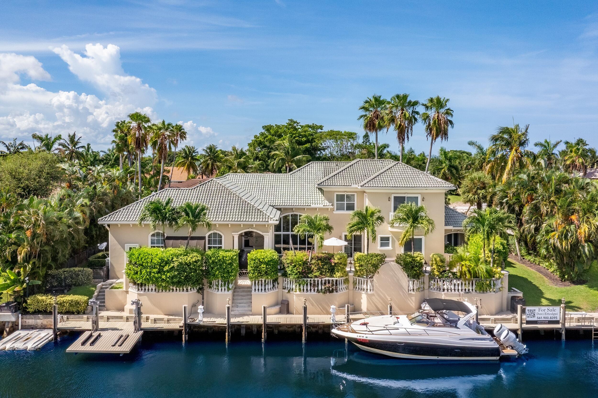 Tucked within the prestigious enclave of Boca Bay Colony, this waterfront estate blends timeless elegance with resort-style living. Set on over one-third of an acre with 150 feet of deep-water frontage, this five-bedroom, six-and-a-half-bath residence is designed for the ultimate South Florida lifestyle, complete with multiple boat accommodations, two floating jet ski docks, and a wide canal offering seamless ocean access.

Inside, polished Saturnia marble flooring, high ceilings, and expansive windows fill the home with natural light. The open-concept layout flows effortlessly into the tropically landscaped backyard, where an elevated dock, authentic reclaimed coral decking, and a protected pool area create a private marine sanctuary perfect for entertaining or relaxing year-round. The chef's kitchen is outfitted with granite countertops and KitchenAid appliances, while the second-floor primary suite offers a private retreat with a sitting or exercise room, spa-style bath with sauna, and dual walk-in closets. Each bedroom is en-suite, including one guest suite with a kitchenette and private side entrance to the maids quarters, ideal for long-term guests or staff.

Additional highlights include a private office, full-house generator outdoor speakers, and an epoxy-coated garage. The home also features a full-property invisible dog fence and is equipped with impact-rated windows and garage door for peace of mind.

The entire exterior was repainted, making this meticulously maintained estate ready for immediate enjoyment. Just bring your boat. Shown by appointment only. 

The information published and provided including but not limited to prices, measurements, square footages, lot sizes, features, finishes, and calculations are subject to errors, omissions or changes without notice. All such information should be independently verified. All parties should perform their own due diligence to verify all information.