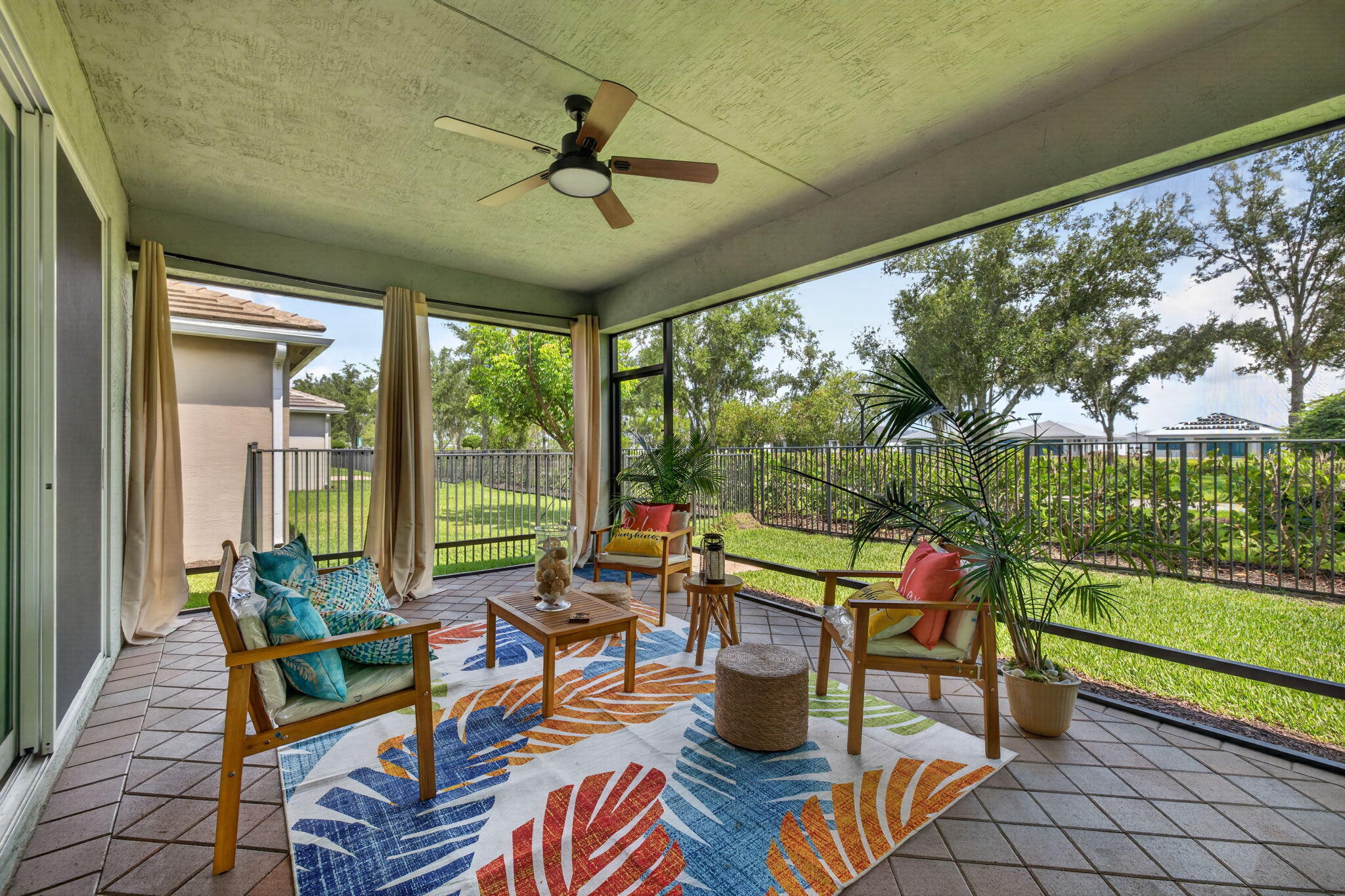 Welcome to 13388 SW River Rock Drive, located in Valencia Grove at Riverland — one of Port St. Lucie's premier 55+ lifestyle communities in the heart of Tradition.  Perfectly positioned along the Paseo walking and biking path, this beautifully designed GL Homes residence offers peaceful, private views and direct access to one of Riverland's most loved outdoor features — ideal for morning walks, bike rides, or golf cart trips through the community.  Built with solid CBS construction, a concrete tile roof, and full impact glass throughout, this move-in ready home offers 3 bedrooms, a versatile flex room ideal for a home office or den, 2.5 bathrooms, and a spacious 2-car garage.   Inside, the open-concept floor plan blends comfort and functionality with thoughtful upgrades throughout. The kitchen is designed for both everyday living and entertaining, featuring a gas range, granite countertops, 42-inch cabinetry with pot-and-pan drawers, adjustable shelving, and abundant storage. Plantation shutters add warmth and timeless style, while the gas tankless water heater provides energy efficiency and endless hot water.  Step outside to your oversized screened patio and enjoy the tranquil Paseo backdrop — a perfect space to relax, entertain, or simply enjoy Florida's year-round sunshine.  Why wait 8-12 months for new construction when this home is ready now? Here, you avoid builder delays, added upgrade costs, and the extra expenses that often come after closing — including window treatments, ceiling fans, appliances, and landscaping. Plus, this section offers no CDD, making the overall value even stronger.  As a resident of Valencia Grove, you'll enjoy access to a 34,000-square-foot clubhouse and Riverland's expansive Sports & Racquet Club featuring resort-style pools, pickleball, tennis, fitness and wellness spaces, walking trails, bocce, and a full calendar of clubs, events, and social activities.  Convenience is unmatched. Enjoy dining within the community at Grove Kitchen & Bar and River Fresh Café, or take your golf cart through the Paseo to the new Riverland Town Center for additional shopping and services. Just outside the community, explore all that The Heart in Tradition has to offer, including restaurants, boutiques, coffee shops, and community events. Within minutes, you'll also find even more shopping, dining, and entertainment throughout Tradition and Port St. Lucie.  Nearby conveniences include Cleveland Clinic Tradition Hospital, easy access to I-95 and Florida's Turnpike, and the beautiful Treasure Coast beaches.  Resort-style living, modern construction, and an unbeatable location — all ready for you now. Schedule your private showing today.