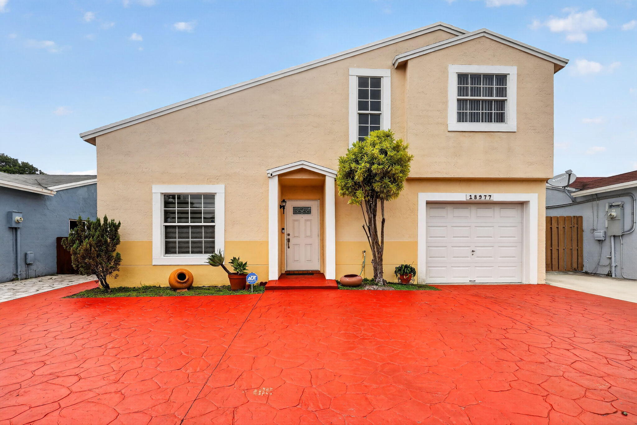 Welcome to this beautifully maintained 3-bedroom, 2.5-bath home located on a quiet cul-de-sac in one of Miami Gardens' most convenient and family-friendly neighborhoods. Situated directly across from Joella Good Elementary School and a beautiful community park, this property offers an ideal blend of comfort, location, and modern upgrades.  Inside, you'll find a spacious and versatile floor plan featuring an extra-large bonus room built within the garage area. Currently used as a home office, this flexible space connects directly to the primary suite and can easily serve as a private office, gym, nursery, hobby room, or additional living area. The home has been thoughtfully updated with high-impact windows, doors, and garage door, providing peace of mind and energy efficiency. The recently painted interior creates a fresh and inviting atmosphere, while the kitchen features brand-new appliances ready for the next owner. The primary bathroom has been updated with a new double-sink vanity, and additional upgrades include a tankless water heater, newer Samsung washer and dryer, and new window blinds in select areas.  Outdoor living is equally impressive, featuring a covered backyard patio perfect for entertaining, relaxing, or enjoying South Florida's beautiful weather. The backyard also includes a new storage shed for added convenience. The oversized driveway provides parking for up to five vehicles, a rare and valuable feature.  Residents enjoy access to another private community park with a scenic lake located just down the street. The location is unbeatable, with supermarkets, shopping centers, Walmart, Walgreens, banks, restaurants, and schools all nearby. Commuters will appreciate being approximately one mile from the Palmetto Expressway, two miles from I-75, and four miles from I-95, providing easy access throughout South Florida.  This move-in-ready home offers the perfect combination of space, upgrades, convenience, and location. Schedule your private showing today and discover everything this exceptional property has to offer.