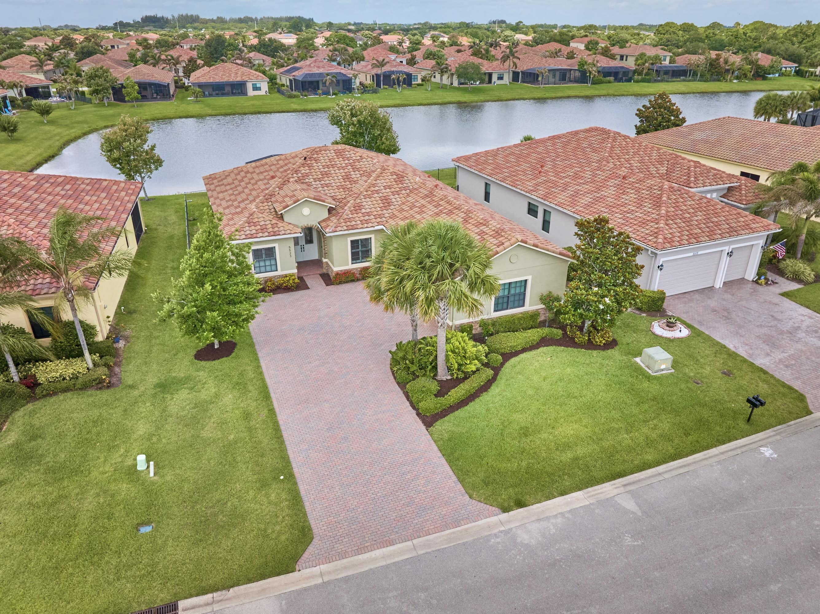 VEROLAGO WATERFRONT POOL HOME w/RESORT-STYLE AMENITIES! Beautifully appt'd 3BR+DEN, 2BA, 3CAR GAR. 2026: NEW HVAC,Interior paint, LED lighting. OPEN CONCEPT layout ideal for indoor/outdoor living boasts pool & water views from living/dining areas & BedrmSuite. ENTERTAINING KITCHEN: Massive Island seats 7-8, granite CTs, SS appl's & 42" cabs +pantry. BEDRMSUITE: dbl-door entry, tray ceiling, recessed lights, mid-wall TV outlet, vinyl plank flr & oversized walk-in closet w/custom built-ins & ensuite bathrm. INTERIOR LAUNDRYRM: folding station, w/d, utility sink, upper/lower cabs, open shelving/hanging space.  FEATURES: IMPACT WINDOWS, plantation shutters, 10'ceilings & 8'doors. Cathedral screened-enc'd pool/patio, long covered patio & private Doggy Run. SEE HOME COME TO LIFE -SEE VIDEO!