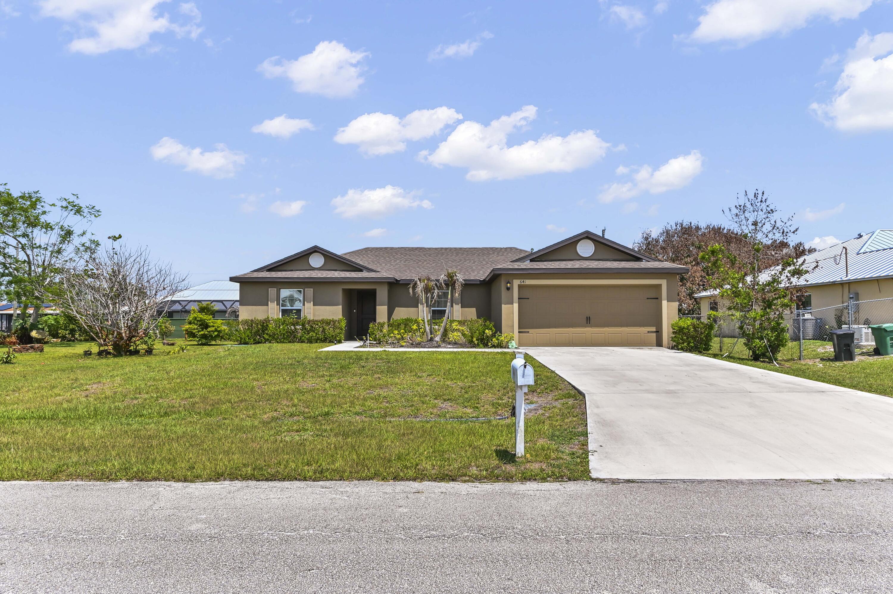 Welcome to 641 SW Addie Street, a move-in-ready Port St. Lucie home that immediately stands out with its bright, welcoming interior and easy-flowing layout. The main living area feels open and comfortable, offering plenty of natural light and a seamless connection between the living, dining, and kitchen spaces—perfect for everyday living, hosting friends, or simply relaxing at home. The kitchen offers a clean, functional setup with generous cabinet space and a practical layout that keeps everything within reach. The bedrooms provide comfortable retreats with flexibility for family, guests, or a home office, while the updated feel throughout the home gives it a fresh and inviting atmosphere. The bathroom adds to the home's appeal with a crisp, modern look that feels both stylish and convenient.  Outside, the property offers the kind of usable outdoor space that makes Florida living so enjoyable, with room to entertain, garden, play, or create your own private backyard retreat. Set in an established Port St. Lucie neighborhood near shopping, dining, schools, parks, and commuter routes, this home combines comfort, functionality, and location in one appealing package.