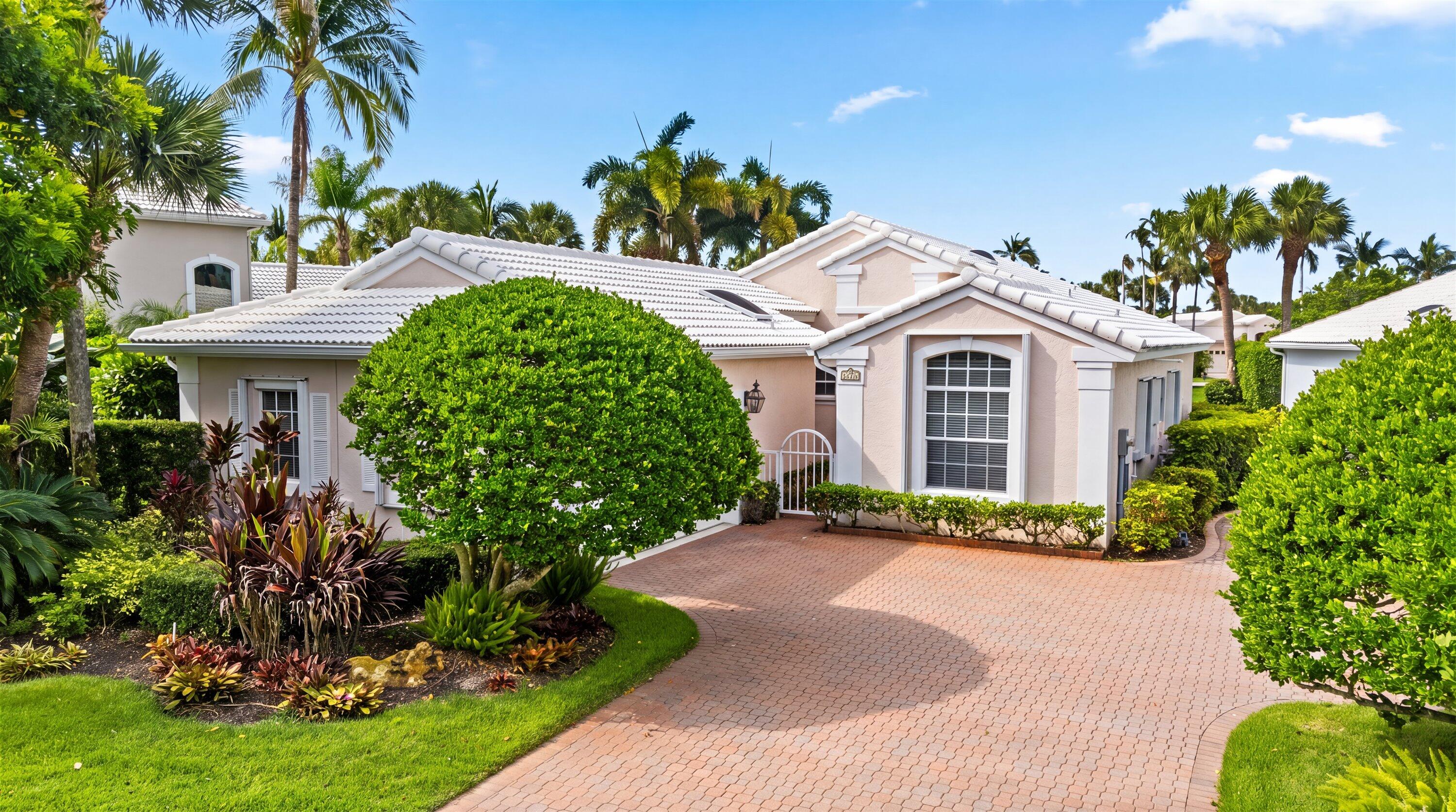 Lakefront living in Longshore, one of Jonathan's Landing's most intimate enclaves of just 24 single-family homes. Behind a courtyard entry, this meticulously maintained residence sits on a serene lakefront lot with a screened lanai designed to embrace the peaceful water views. Inside, a light-filled foyer opens to soaring volume and vaulted ceilings with skylights. A smart split-bedroom layout places the primary suite and guest bedroom on opposite ends for privacy, while a versatile flex room is ideally suited as a third bedroom, home office, or media room, offering the flexibility to adapt to your lifestyle. Two living areas anchor the home: a spacious living room overlooking the lake and a family room open to the kitchen, where granite counters, wood cabinetry, stainless appliances, and a sunlit breakfast area make daily living effortless. Outside, lush, professionally landscaped tropical grounds and paver walkways complete the setting.  Additional images are conceptual renderings illustrating the home's renovation potential. Furnishings, finishes, fixtures, and design elements shown in the renderings are for inspiration only and do not reflect the home's current condition. Located in Jupiter, Florida, Jonathan's Landing is a premier private gated community offering an exceptional club lifestyle with three renovated golf courses, tennis, pickleball, a modern Wellness Center, dining, and an active social calendar, all just minutes from Jupiter's beaches, marinas, shopping, and fine dining.