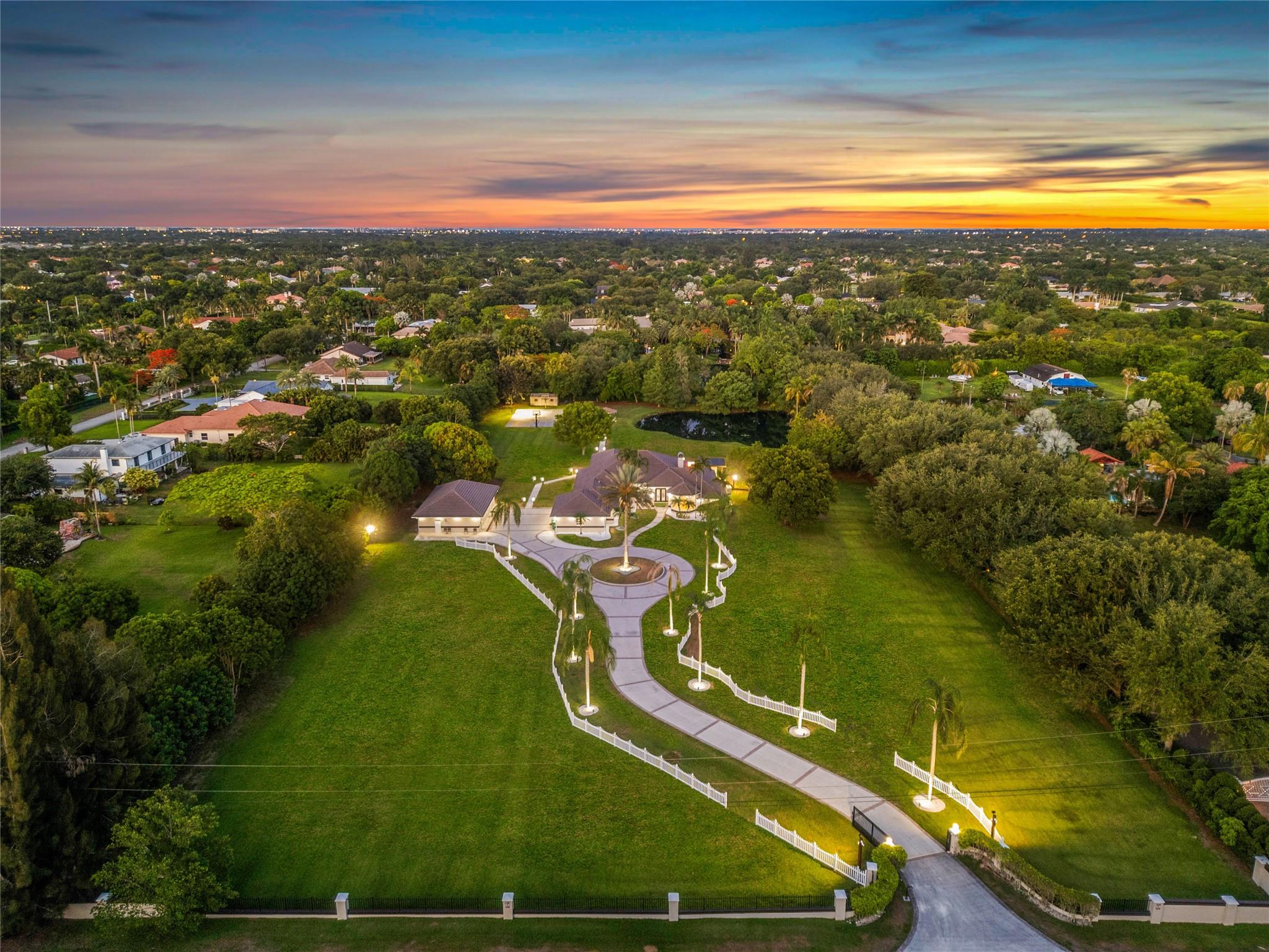***THE ULTIMATE FAMILY COMPOUND LOCATED IN THE HEART OF DAVIE!!!*** THIS PROPERTY IS PERFECT FOR THOSE NEEDING SPACE OR WORKING FROM HOME! PRIVATE & SECLUDED THIS HIDDEN GEM IS NESTLED ON 4.2 ACRES (288'X634'), TOTALING OVER 6,700 SQFT. THE MAIN HOUSE (4,695 SQFT) INCLUDES 5 BEDROOMS W/4 FULL BATHS & HUGE CONVERTED GARAGE CURRENTLY BEING UTILIZED AS A HOME OFFICE. STEPS AWAY IS A DETACHED 1,500 SQFT GUESTHOUSE W/2 BEDROOMS/2 BATHS, FULL KITCHEN DINING/LIVING ROOM. BEGIN AND END YOUR DAYS LOUNGING ON THE PATIO WATCHING THE GORGEOUS SUNRISES OR RELAXING POND W/WATER FEATURE &LITE FULL BASKETBALL CT. NEW DECK &FULL SUMMER KITCHEN W/REFRIG & ICEMAKER. RESURFACED POOL& RAISED SPA. THE PROPERTY IS COMPLETED W/A 38KW FULLHOUSE GENERATOR W/1000GAL GAS TANK. 26 EXTERIOR CAMERAS. SEVERAL FRUIT TREES