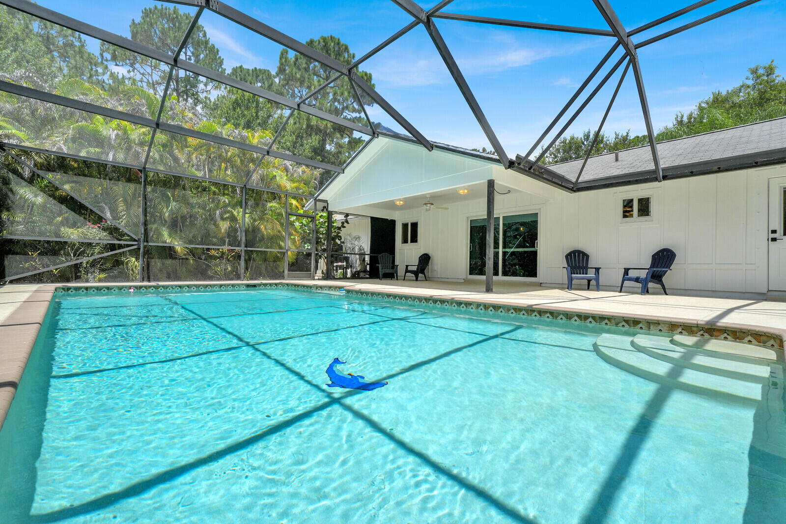 If you are looking for an extremely Clean & well maintained Home, this Charming 3-bedroom, 2-bath home Pool Home featuring a desirable split floor plan, vaulted ceilings, & new Italian porcelain tile throughout is the one for you. Enjoy peace of mind with complete IMPACT glass windows and doors, an updated kitchen, & reverse osmosis water system. Step outside to a screened POOL and spacious patio overlooking a private, fenced yard with mature fruit trees and an automatic electric gate. Additional features include a new oversized shed with high ceilings and ample storage. Ideally located just steps from preserve trailheads offering hiking and biking opportunities. A perfect blend of comfort, privacy, and outdoor living and with no HOA you can enjoy all the freedoms this area has to offer.