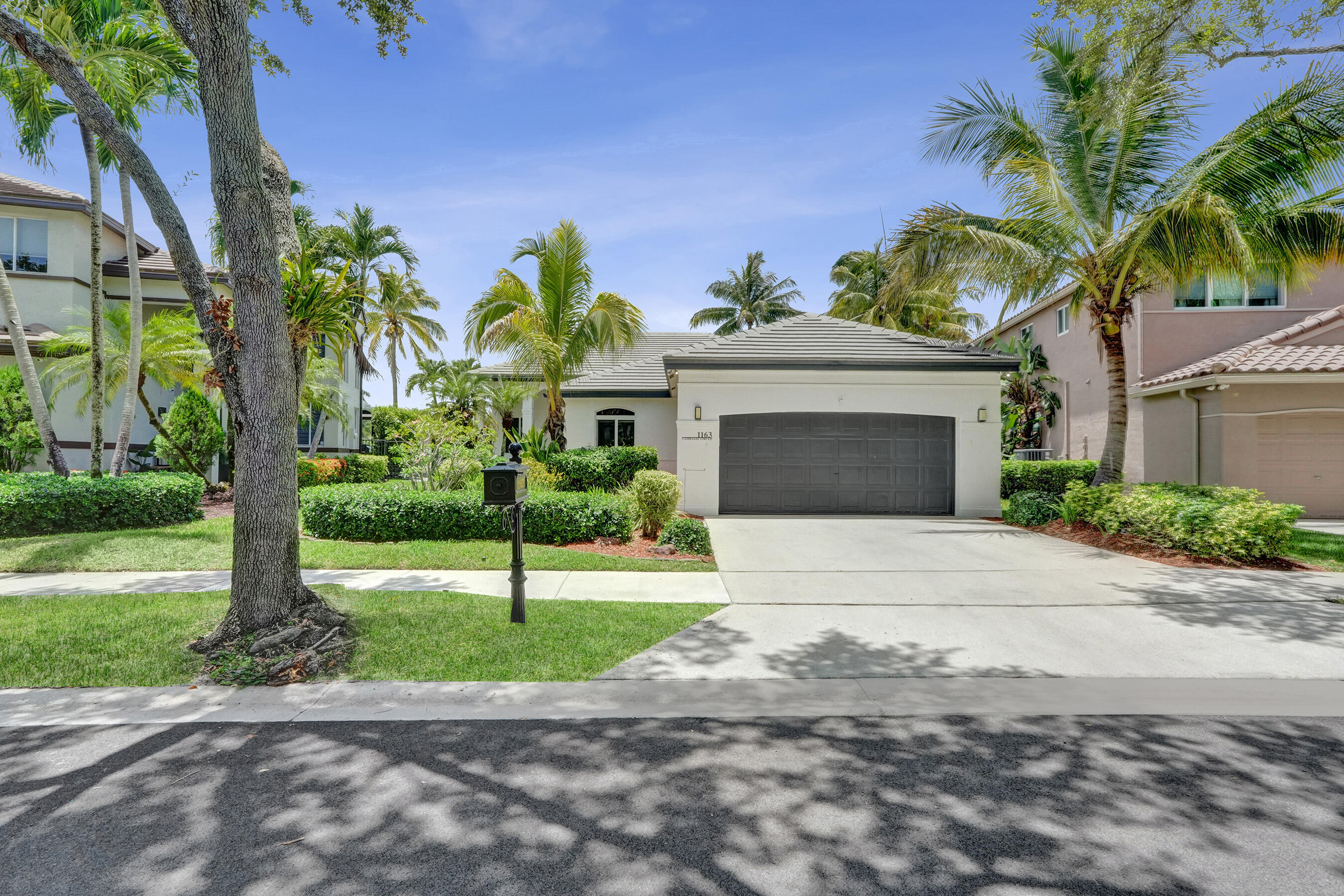 Camellia Island, one of Weston's hidden treasures. Located within a guard gated community, this beautifully appointed one story waterfront home offers wide lake views, warm contemporary finishes, and an inviting blend of elegance and comfort. Featuring 3 bedrooms plus a den and 3 bathrooms, the light filled interior showcases soaring ceilings, rich wood flooring, and an open floor plan. The chef's kitchen, renovated in 2021, is highlighted by a large picture window that fills the space with natural light. Updates include a 2022 roof, 2023 impact windows and doors, renovated bathrooms with LED illuminated spa inspired mirrors, custom closets, a smart lake fed irrigation system, and a screened pool and spa overlooking 55 feet of waterfront.