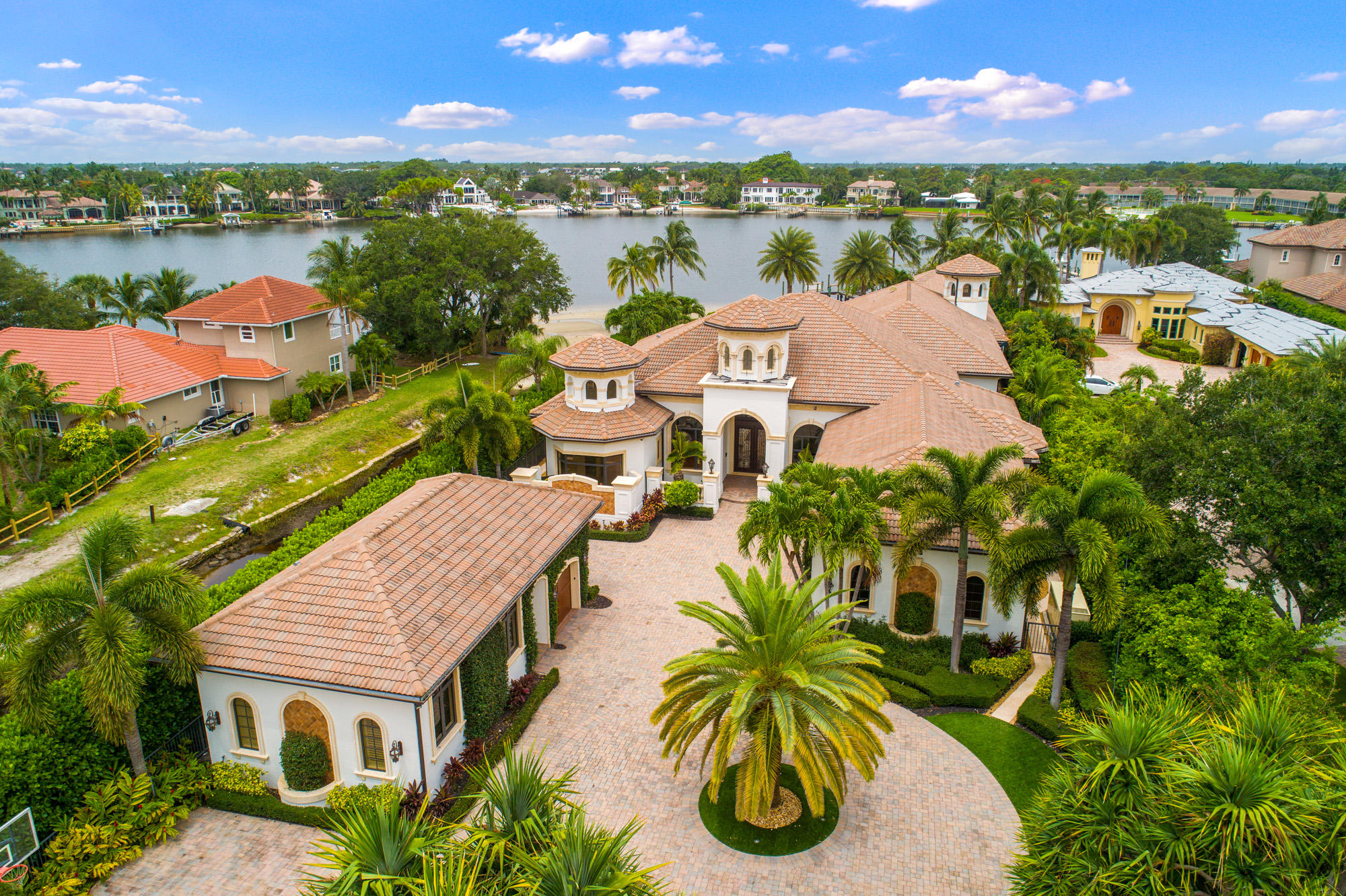 Boasting over a 135' OF RIVERFRONT AND STUNNING PANORAMIC WATER VIEWS OF THE LOXAHATCHEE RIVER, this private single-story grand estate is a true masterpiece.  Set on an EXPANSIVE 1 ACRE PARCEL and located on sought-after Riverside Drive, this 10,000+ sq. ft. home, was BUILT EXCEPTIONALLY WELL IN 2009 with HIGH QUALITY CRAFTSMANSHIP AND ATTENTION TO DETAIL. Upon entering thru the private gates, you feel welcomed to this spectacular property and attractive home that features 4 spacious bedroom all with on-suite bathrooms, an office, 2 dining rooms, 2 PROFESSIONAL INDOOR BOWLING LANES, a guest house with kitchenette and separate garage.  (See supplement for more details). The chef's kitchen features fine custom cabinetry, highest quality appliances including COMMERCIAL GRADE SUBZERO REFRIGERATOR AND FREEZER, 8-BURNER PROFESSIONAL GAS COOKTOP, and butler's pantry. The spacious living room with gas fireplace, open family room with built-in entertainment center which flows seamlessly into oversized covered patio with summer kitchen.  Other features include hurricane impact doors & windows, AWARD-WIINNING SMART/HOME AUTOMATION TECHNOLONGY that controls all lighting, ACs, entertainment, security systems, front gates and more; temperature-controlled wine cellar, detailed custom ceiling woodwork, electric shades, circular driveway; generator; salt chlorinated heated pool and spa; outdoor shower; lush landscaping and syncretic turf front and back, a fully equipped dock with boat lift and another dock for beach area.  The Bowling Alley is approximately 2000sq ft under air and is ready plumbed / ready to be reconstructed to 3 bedrooms with their own unsuits or master bedroom suite with another bedroom with ensuite; all with spectacular river views.  Ask listing agent about floor plan and construction cost.  Some of the photos in the MLS are virtually staged. The actual rooms sizes are very large with high ceilings and crown molding.  Additionally, please view bowling alley floor plan redone to include 3 bedrooms suites.

Location! Location! Location! Jupiter has become one the premium spot to live in south Florida and the world. It has the best that life has to offer all in 1 mile radius. Incredible water sports & fishing right in your dock, and less than 1 mile from the beautiful Jupiter Inlet. The area offers exceptional A-rated schools, world class restaurants and shopping along the waterfront that you can access within 5 minutes via boat or car, some of the best golfing anywhere, and spectacular beaches, all within 30 minutes from PB international airport.