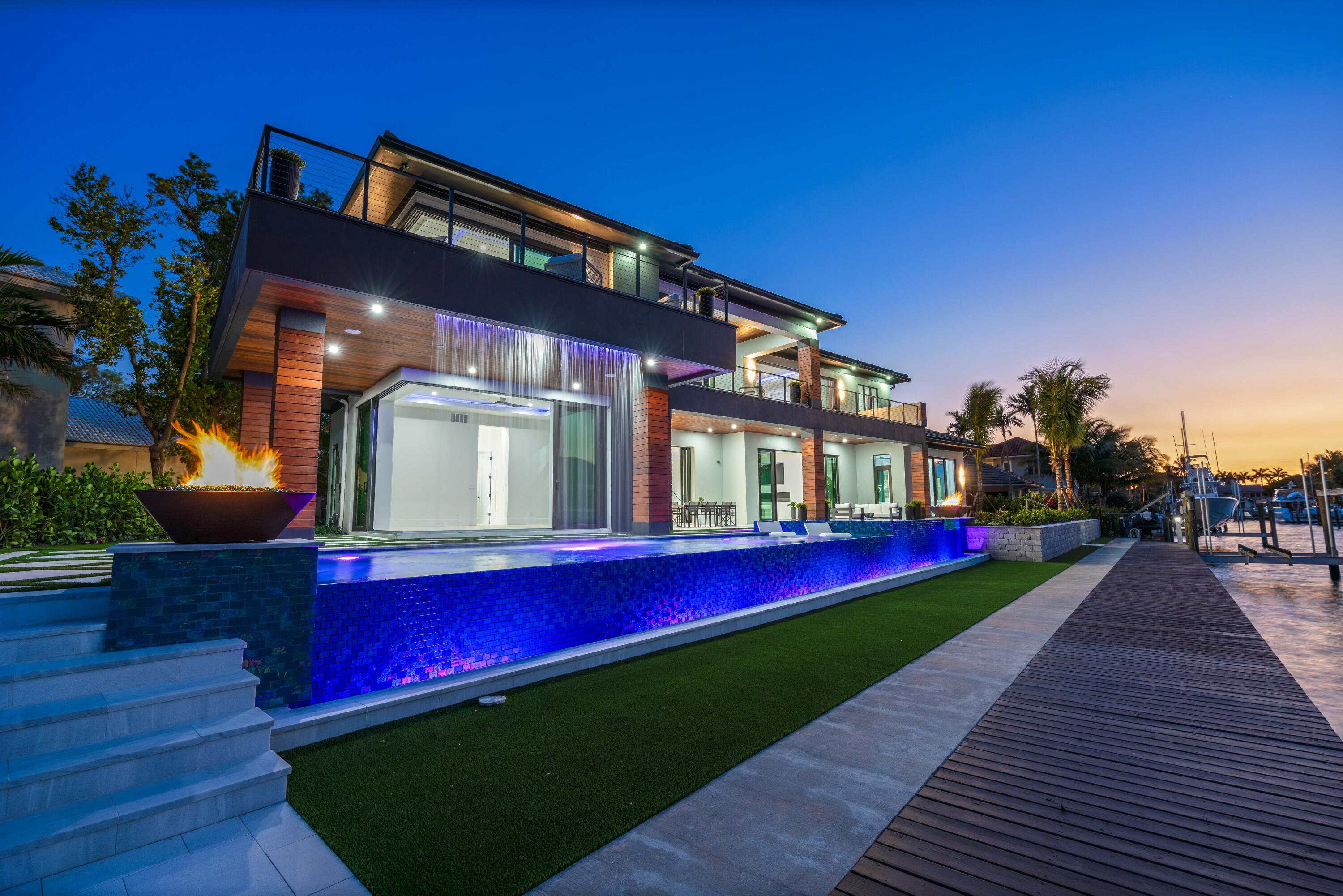 BRAND NEW 2024 WATERFRONT CONSTRUCTION  AND BIG WATER VIEWS!  Bring your largest vessels and dock directly behind this stunning estate home tucked away at the end of prestigious Bowsprit Drive in North Palm Beach. Situated on 150' of deep water with mooring piles and 24K lift! Meticulously engineered to capture wide water views from nearly every space with 90-degree sliding glass doors from the upper level primary suite to 10' tall 90-degree pocketing sliders in the lower level club room. Generously appointed and specifically designed with entertaining in mind, this home is the epitome of South Florida indoor-outdoor living with expansive covered patio and balcony areas, infinity-edge saltwater pool/spa and 60'' fire pit and conversation area, summer kitchen and smart home technology!