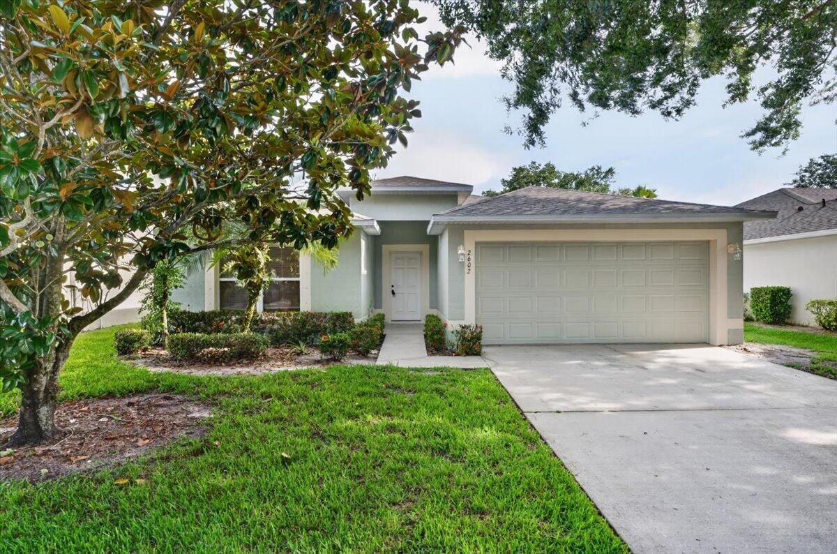 New Roof, Lake View & Lawn Care Included! Located in the gated Majestic Oaks community, this 3-bedroom, 2-bath home offers a 2-car garage, vaulted ceilings, and a screened porch overlooking the lake.  Major updates include a NEW 2026 roof, newer 2024 HVAC, NEW interior and exterior paint, and new vinyl flooring throughout. The layout flows effortlessly- with a large living room, dining area, and living room with sliding doors leading to the screened porch with a lakeview- perfect for morning coffee or relaxing evenings  The kitchen offers abundant cabinet and counter space plus a breakfast nook. The spacious primary suite includes a walk-in closet and an ensuite bath with a separate tub and shower.  Residents enjoy a pool, basketball court, playground, and low maintenance Florida lifestyle