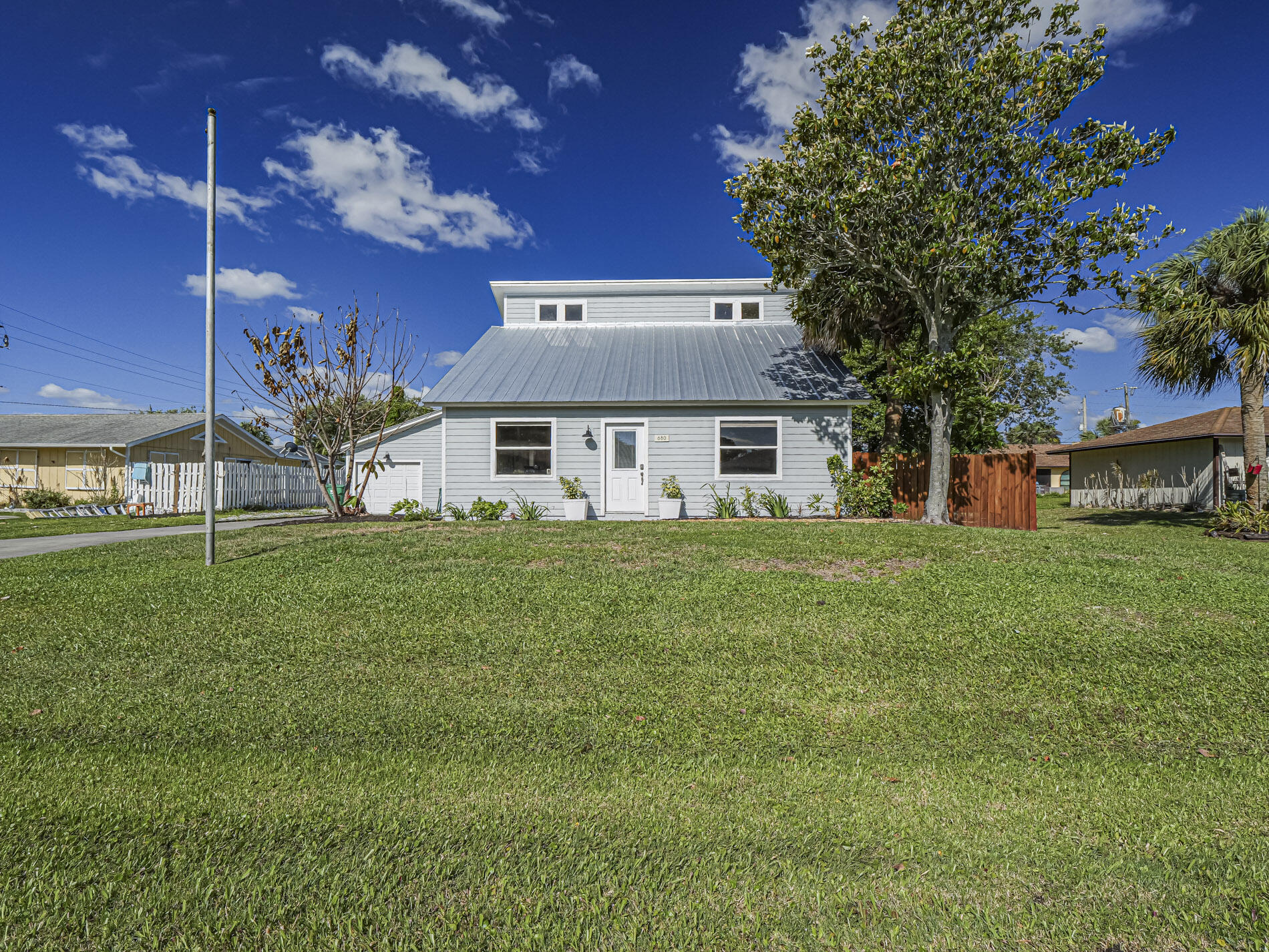 Sebastian, Florida! This one-of-a-kind, beautifully remodeled three-bedroom, two-bath home blends character, style, and versatility with thoughtful upgrades throughout, including a 2023 metal roof, Hardie siding, a quartz kitchen, stainless steel appliances, updated bathrooms, luxury vinyl flooring, white-washed cedar plank paneling, and custom built-ins. Every detail has been designed with both beauty and function in mind. Outside, enjoy a fully fenced yard, perfect for pets, privacy, or entertaining. The detached garage offers endless potential for a guest cottage, art studio, workshop, or flexible space. No HOA in a prime location.