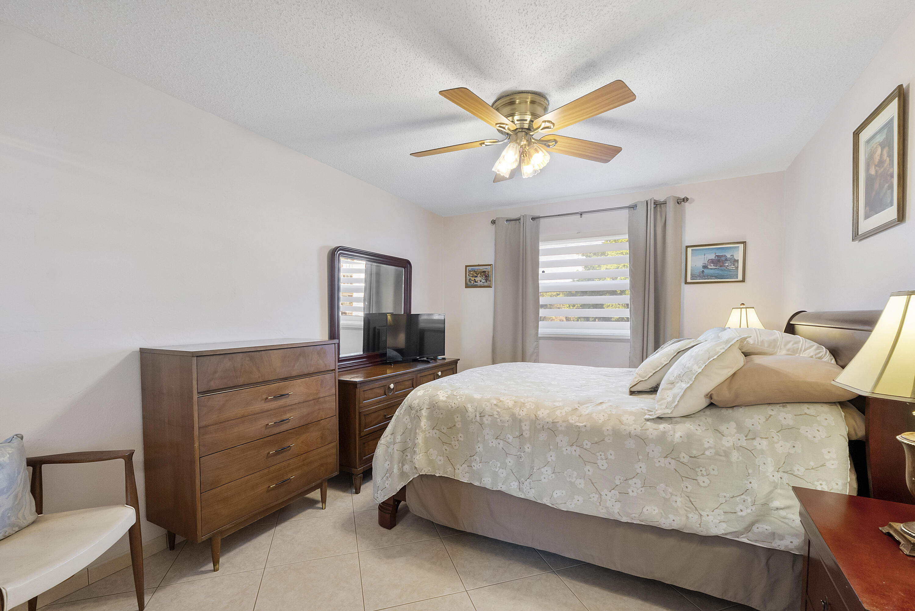 Excellent location! Beautifully upgraded and exceptionally spacious 2-bedroom, 2-bath second-floor condo. This move-in-ready residence can be sold furnished, offering a seamless transition for its next owner. The expansive primary suite features a large walk-in closet to meet all your storage needs. Enjoy relaxing in the enclosed Florida room with serene lake views—perfect for year-round comfort.  This home blends comfort, convenience, and a touch of luxury. The Garnet Condominium is a 55+ community offering a wide range of amenities, including tennis, a heated pool, fitness center, library, bocce ball, and BBQ area. Ideally located within walking distance to schools and just minutes from major highways and beautiful beaches—perfect for full-time living or a seasonal retreat.