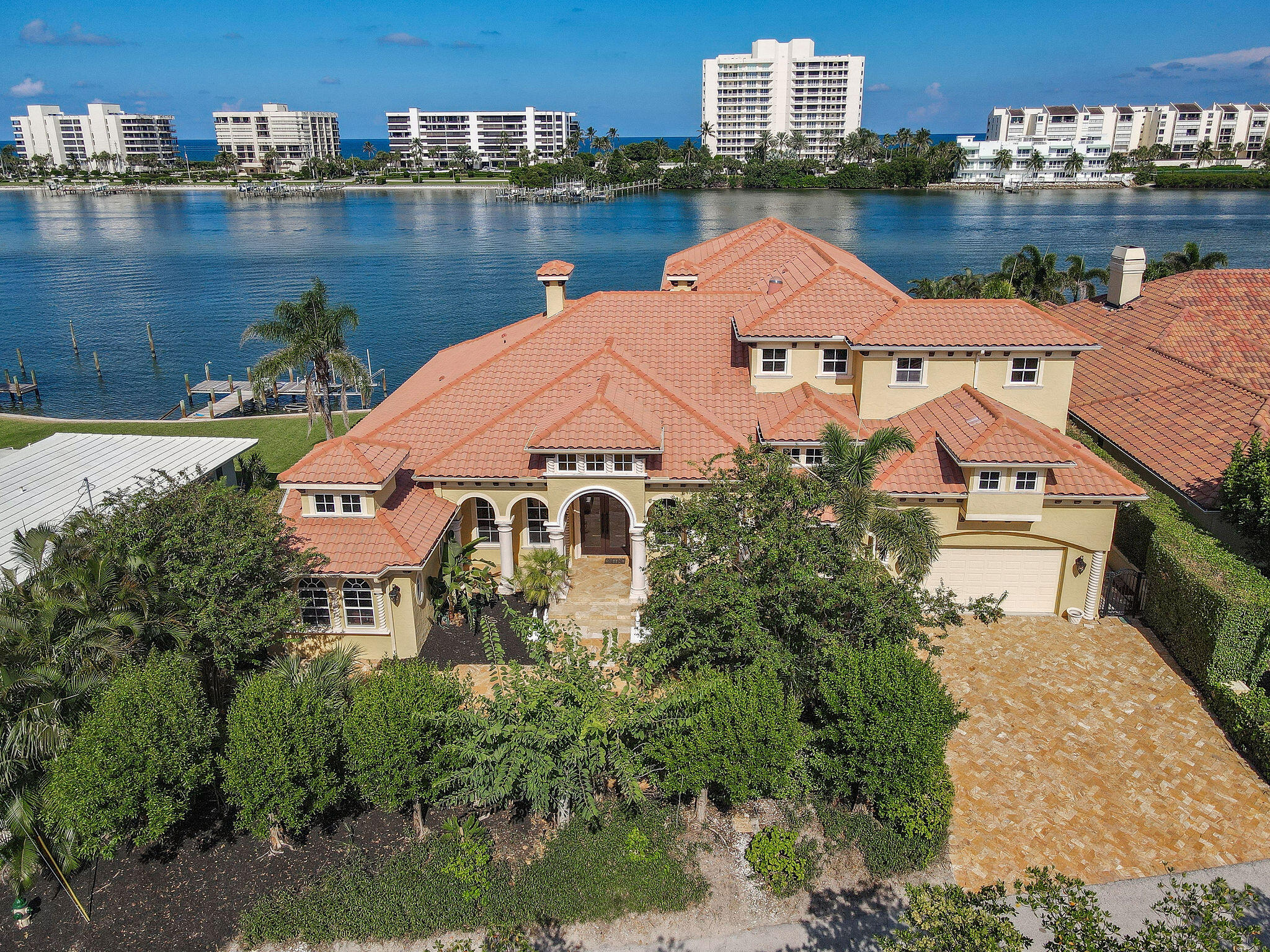 Stunning estate residence situated along the coveted Intracoastal Waterway with its mesmerizing Bahama-blue waters in sought-after Jupiter. This remarkable property boasts a host of desirable amenities, including a fully equipped in-law suite complete with a bedroom, bathroom, kitchen, and living area. This residence features a spacious gourmet kitchen, theater room (which could easily serve as a fourth bedroom), and a generously sized bar in the primary living area are perfect for hosting gatherings. The home is also equipped with hurricane impact windows and doors, ensuring your peace of mind during storms. For added convenience, an elevator provides access to the second-floor primary suite, which features an expansive covered balcony and patios, perfect for relaxation. Outdoor entertaining is a breeze with a summer kitchen at your disposal, and the property includes a 45kw generator for peace of mind during power outages. Boating enthusiasts will appreciate the private dock and boat lift, offering quick access to the inlet. This truly is the quintessential home for those who love to entertain. Jupiter is a top destination for tennis and golf with its highly coveted courses and local pros. Proudly home to some of the most renowned golf courses in the World. The historic Jupiter Inlet Lighthouse is a testament to the community's long-standing relationship with aquatic pursuits...world class diving and fishing await just offshore. Minutes from Palm Beach International Airport and Stuart Jet Port. For those placing an emphasis on a private, pastoral setting within close proximity to the amenities of an idyllic community like Jupiter, 19709 Harbor Road N, is an unparalleled offering.

Per seller; first floor interior columns are not load bearing and can be removed at buyers discretion.