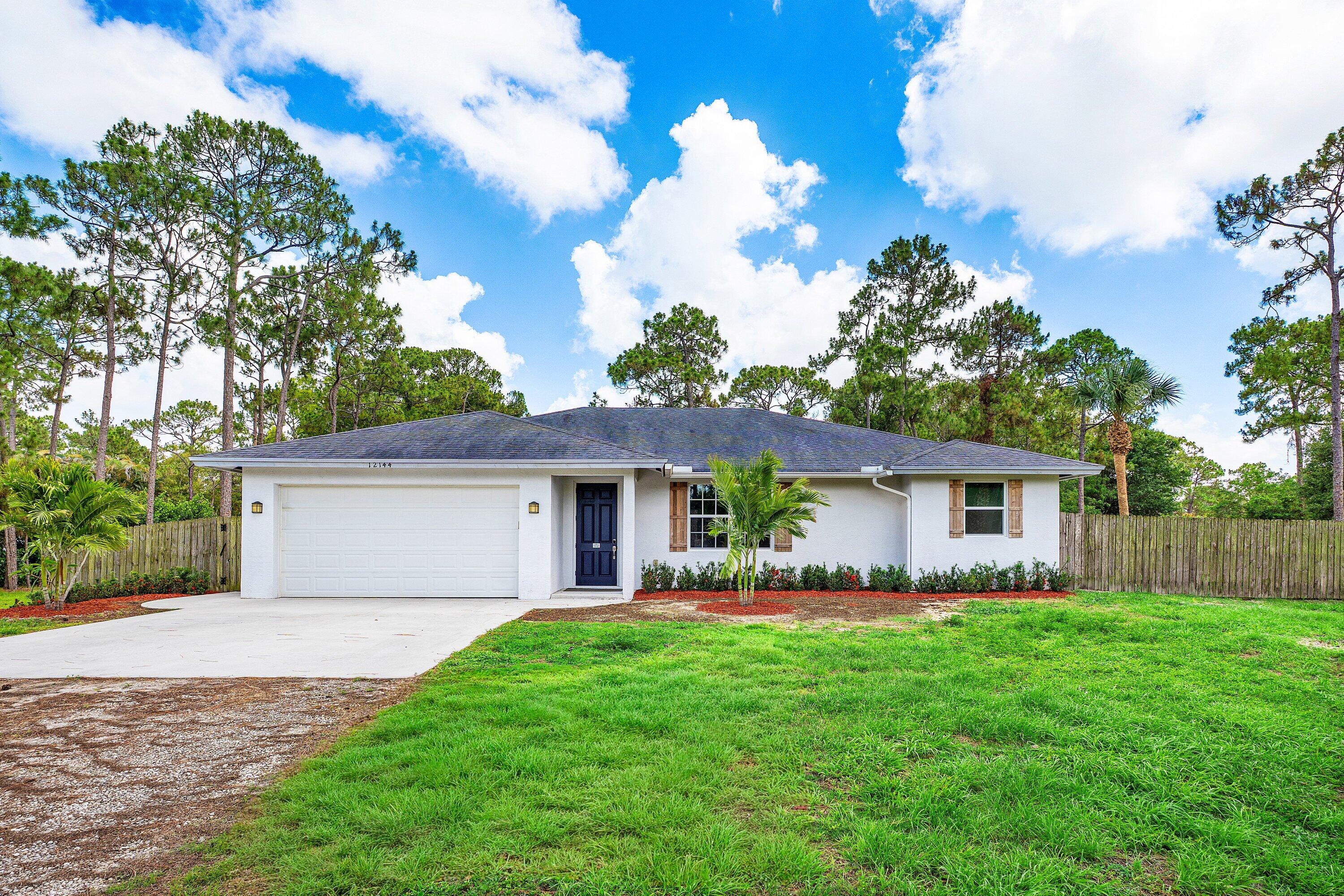 Welcome to 12144 62nd Lane N in West Palm Beach, Florida—a beautifully crafted custom home situated on a private 1.25-acre lot in the highly desirable Acreage community. Built in 2019, this 3-bedroom, 2-bath residence offers approximately 1,789 square feet of thoughtfully designed living space with modern finishes, open-concept living, and plenty of room to enjoy Florida's outdoor lifestyle.  Inside, you'll find a bright and spacious floor plan with 9 ft ceilings and the home features waterproof laminate flooring throughout, impact-resistant PGT windows, and an expansive living area that flows seamlessly into a covered patio through the 8 ft sliding glass doors.  The primary suite offers a peaceful retreat with dual vanities, a frameless glass shower, elegant finishes, and a private water closet. Both bathrooms feature porcelain tile and upscale details that create a luxurious feel.  Located on a fully open 1.25 acre lot, the property provides endless possibilities for a pool, detached garage, workshop, RV and boat parking, equestrian amenities, or future expansion. Enjoy the freedom of acreage living with room to spread out while remaining conveniently close to shopping, dining, schools, parks, major highways, Wellington equestrian venues, Palm Beach International Airport, and Florida's beautiful beaches.  Experience the perfect combination of privacy, modern construction, and country-style living just minutes from all the conveniences of West Palm Beach.