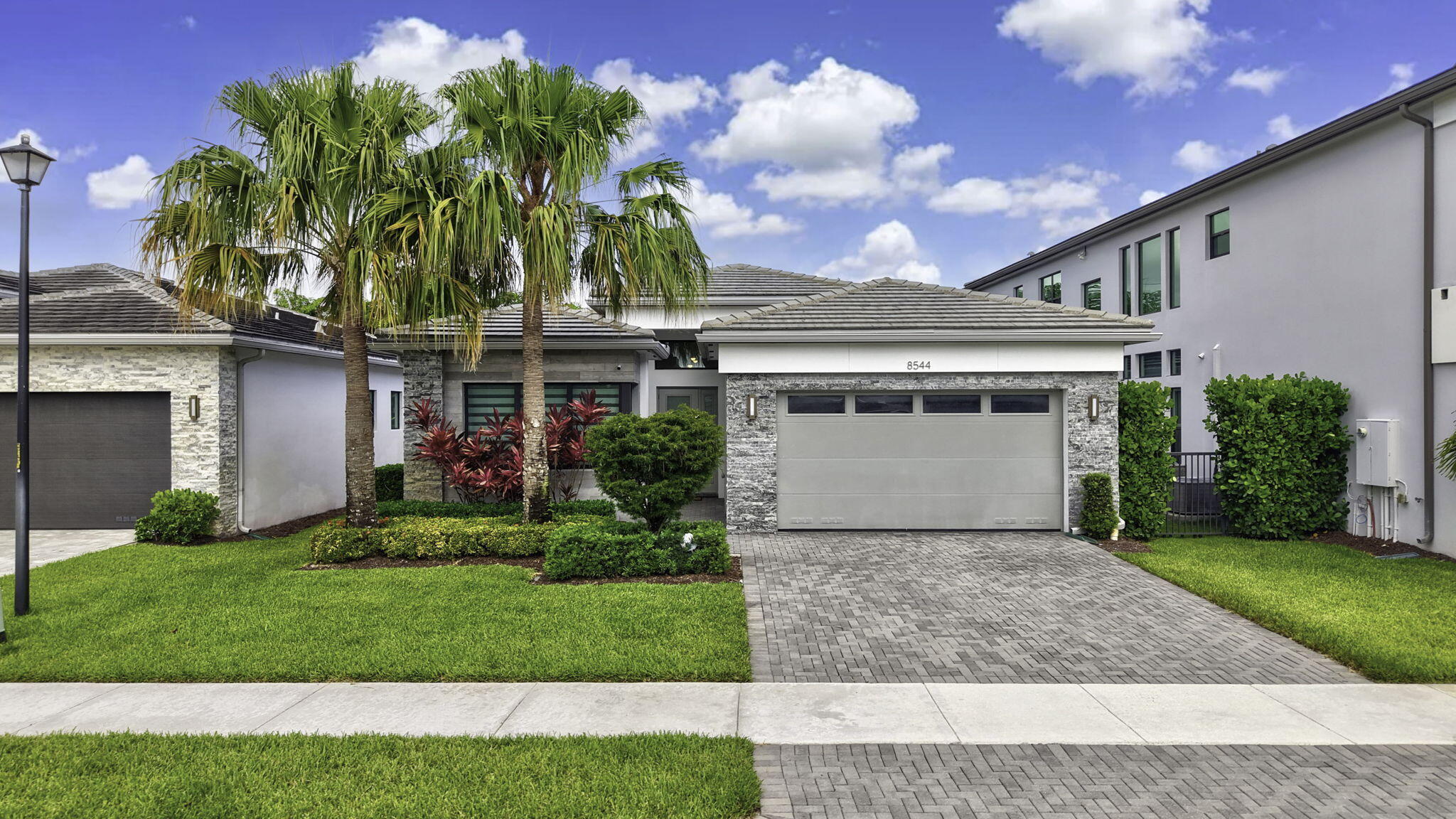 Experience refined contemporary living in this stunning Maui model located within the prestigious gated community of Lotus in Boca Raton. Showcasing 3 bedrooms, 3 full bathrooms, a private den, and thoughtfully designed living spaces, this exceptional residence offers the perfect balance of sophistication, comfort, and resort-inspired living. Upon entry, soaring ceilings, abundant natural light, and elegant designer finishes create an immediate sense of luxury. The expansive open-concept floor plan is ideal for both everyday living and entertaining, seamlessly connecting the great room, dining area, and gourmet chef's kitchen.  Step outside to enjoy South Florida's year-round sunshine from the private backyard, offering ample space for outdoor dining, relaxation, and future customization.  Residents of Lotus enjoy access to an extraordinary array of resort-style amenities, including a spectacular clubhouse, resort pool, state-of-the-art fitness center, indoor and outdoor basketball courts, tennis and pickleball courts, children's splash park, playground, restaurant, and a vibrant social calendar.  Ideally located near Boca Raton's finest shopping, dining, entertainment, top-rated schools, and major transportation corridors, this exceptional residence presents a rare opportunity to enjoy one of South Florida's most sought-after luxury lifestyles.