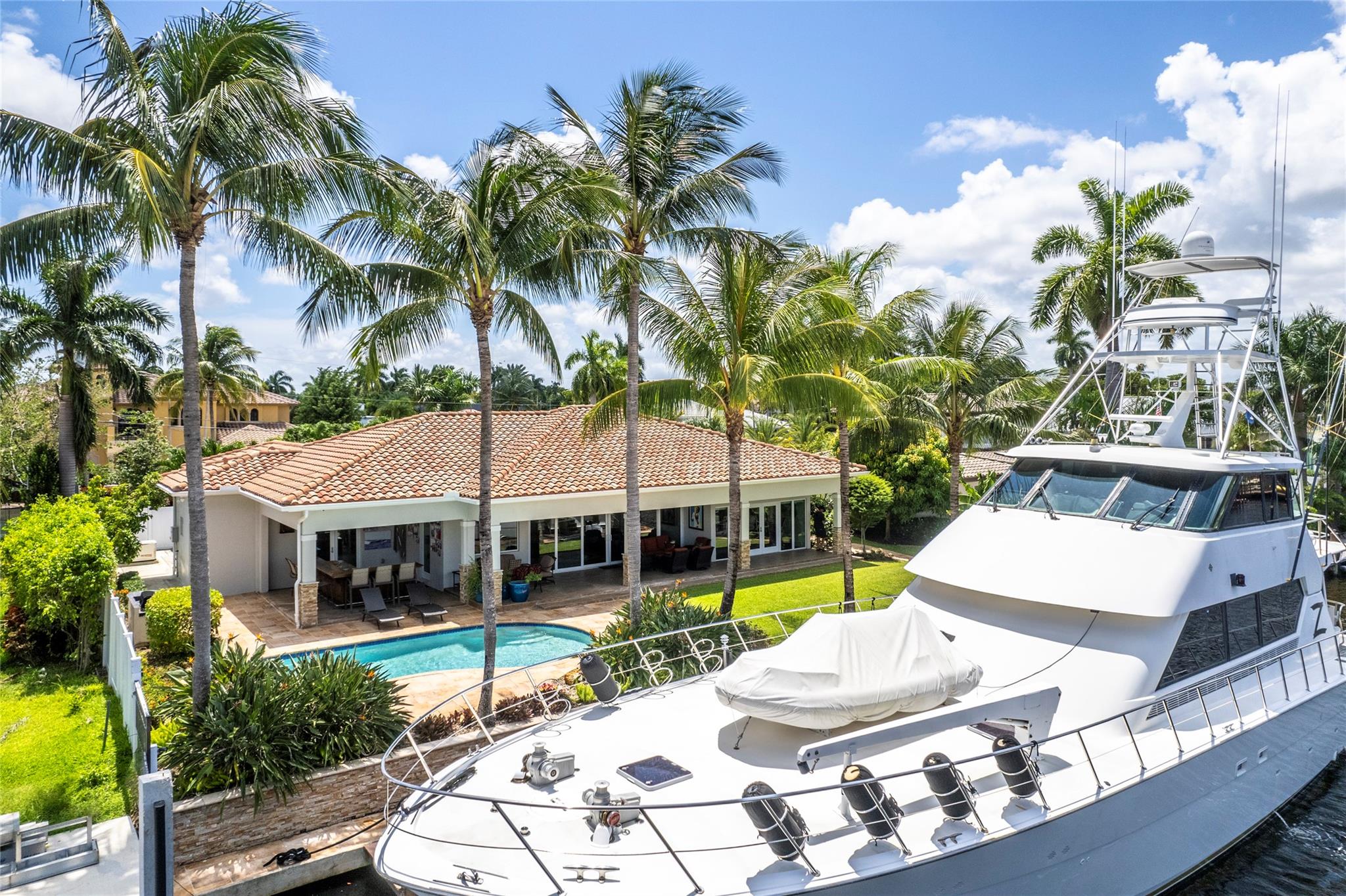 Truly unique & remarkable property, offers a luxurious waterfront lifestyle. Located in a desirable neighborhood, this home boasts a prime waterfront location with wide canal w/100' of water, providing breathtaking views and convenient access to the water. The property features 85 feet dock. Extensive renovations took place in 2019 and includes raised ceilings, new plumbing, electrical panels, new bathrooms, & a modernized open concept kitchen,tankless water heater. Among its notable features is a new 500 gallon propane generator. The outdoor build in bar is a fantastic addition for entertaining and enjoying the beautiful surroundings. Equipped with impact windows and doors. 2 Seperate 200 AMP Breakers. Seawall great condition! Quick access to the Harbour Fort Lauderdale inlet