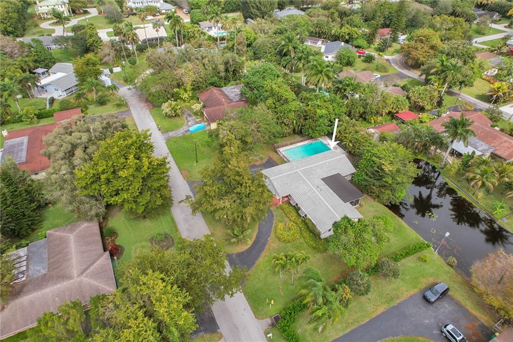 Lily Pond House reminiscent of Monet's beautiful pond, has a perfect serene location in sought after Plantation Acres South. A bit of country and a retreat of your own oversized pool will relax your stress away. Nestled on a cul-de-sac street close to a park, walking bike pathways. Split design providing privacy for large master suite with view of the pond.  Three bedrooms on other side with pool and pond views, full bath and double sinks. Formal dinning area and living room overlooking beautiful screened in porch with a view of pond. Kitchen is open to family room with eat in counter. Tons of extra closet space and huge laundry room. This location provides perfect opportunity to make your dreams come true. Express your creativity and design ideas to make it your forever home.
