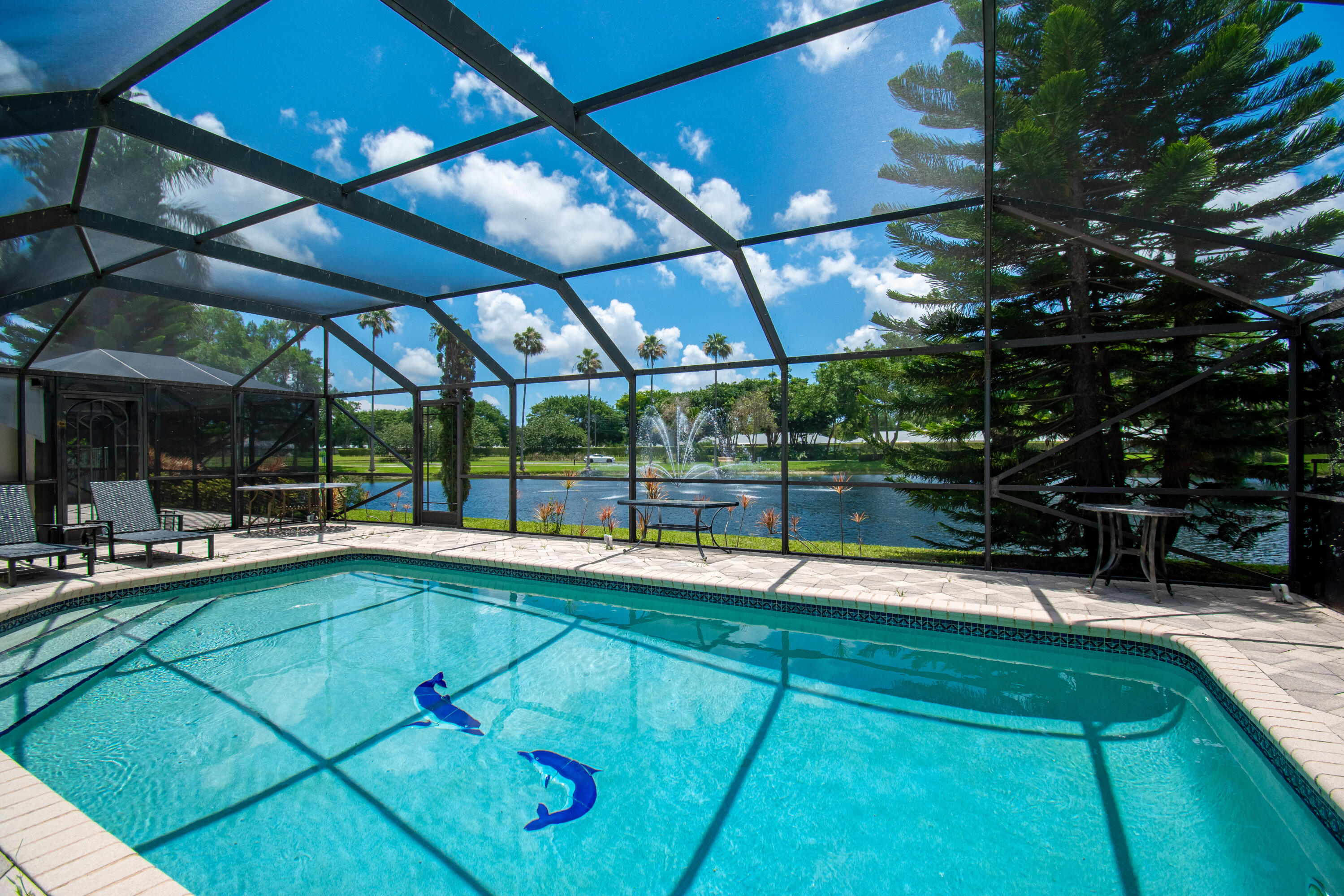 Welcome home to this beautifully maintained turnkey rental located in the desirable man gated community of Villa San Remo in Boca Raton. This spacious home offers soaring ceilings, elegant living and dining areas, crown molding, upgraded lighting & stunning lake views. The updated kitchen features stainless steel appliances, double oven, custom cabinetry, granite countertops & a cozy breakfast area overlooking your own atrium courtyard. The primary suite offers direct access to the screened patio & pool area overlooking the tranquil lake & fountain along with a beautifully updated bathroom. Enjoy indoor-outdoor living from the screened-in patio overlooking the tranquil lake & fountain. 4 month min. Tastefully furnished and move-in ready for tenants seeking comfort, style and a serene..... South Florida lifestyle. The 2 Car Garage has A/C, tile floor and can be used as a Den/Play Room/ Game Room. Villa San Remo is located in central Boca where shopping, fine dining and top rated schools are very close by. Please note: No access..to the community amenities.