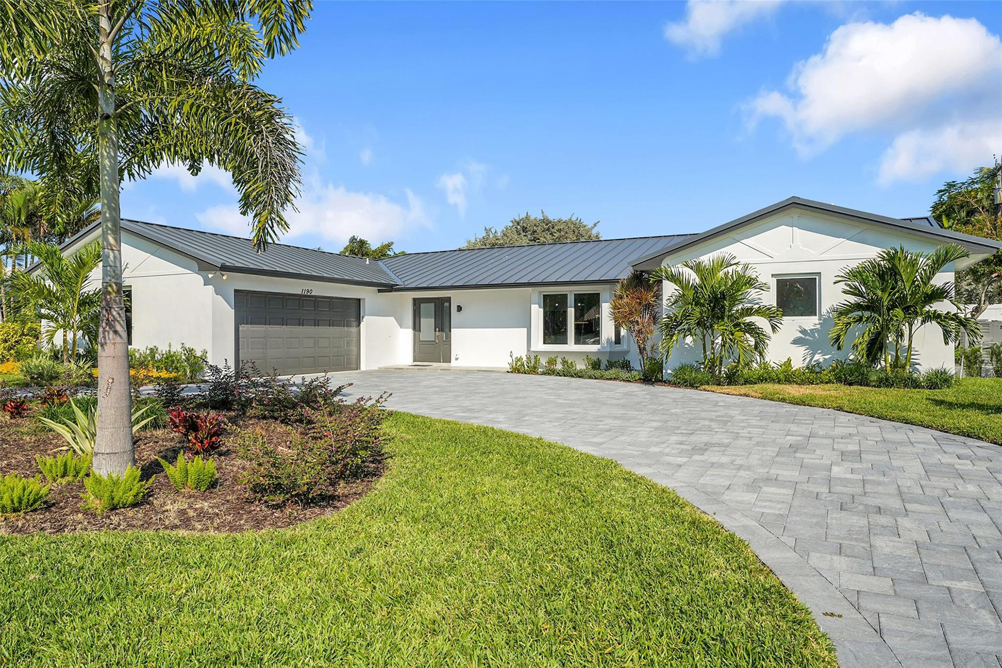 COASTAL LUXURY AT IT'S FINEST! 4/2 POOL HOME! Your new coastal haven has been completely renovated and re-envisioned with tasteful modern finishes and a pallet that is designer friendly. When you enter this bright and airy home, you are greeted by an expansive open floor plan and an elegant center island kitchen at the heart of it all. This home has been updated from the roof to the plumbing, it's truly turnkey. Your new home is just steps to the beach via the Ocean Reef Club directly adjacent this charming & friendly enclave. Just outside of this sanctuary you will find a wide array of activities, Beaches, Shoppes, Fine Dinning, Boating, Night Life & Entertainment and when you've done it all, take a leisurely stroll on the beach or relax in your private pool oasis. Gas generator, impacts.