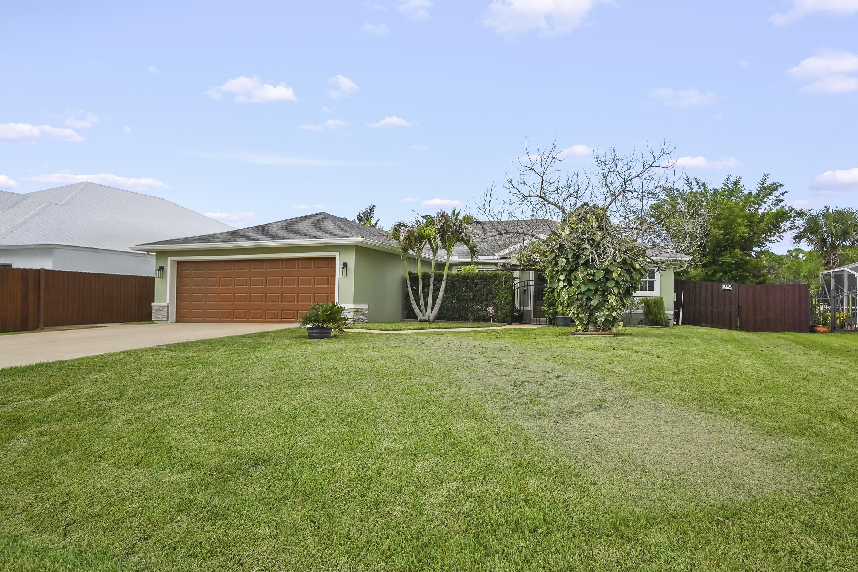 Welcome to 1901 SW Import Drive, a spacious four-bedroom, two-bathroom pool & canal front home offering 1,860 square feet of comfortable, single-story living. Built in 2018, this inviting residence features a bright, open layout that creates an effortless flow between the main living, dining, and kitchen areas—ideal for everyday relaxation, entertaining guests, and spending quality time together. The kitchen serves as the heart of the home with generous cabinetry, ample counter space, and a convenient connection to the surrounding living areas. The private primary suite provides a peaceful place to unwind, while three additional bedrooms offer plenty of flexibility for family, overnight guests, a home office, or a hobby room.  Each space is thoughtfully arranged to deliver both comfort and functionality.  Situated on approximately one-quarter of an acre, the property provides a spacious outdoor setting with room for entertaining, gardening, play, or creating a personalized backyard retreat. Conveniently located near shopping, dining, schools, and major roadways, this NON HOA Port St. Lucie home combines modern construction, versatile living space, and a desirable location ready to complement your lifestyle.