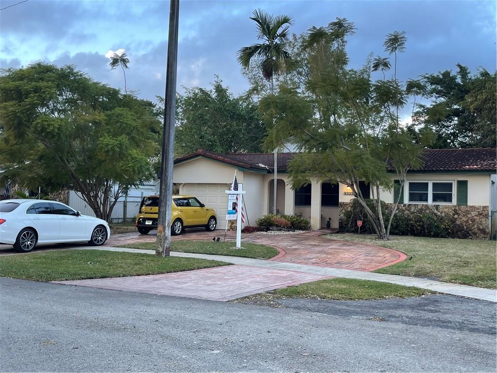 This property has only had one owner. It sits on a 10,220 sq.ft pie shaped lot. Plenty of room for a pool and a second 2 car driveway in the back. It has alley access & back has a lake view. Very serene setting. An upstairs addition serving as a studio or could be 4th bedroom & extra entertaining room were all built with permits. Impact windows front & sides, accordion shutters in back. Garage door also replaced. Flat roof replaced 2019. Circular driveway. 3 large bedrooms and 2 baths.  This property is ready for your personalisation.