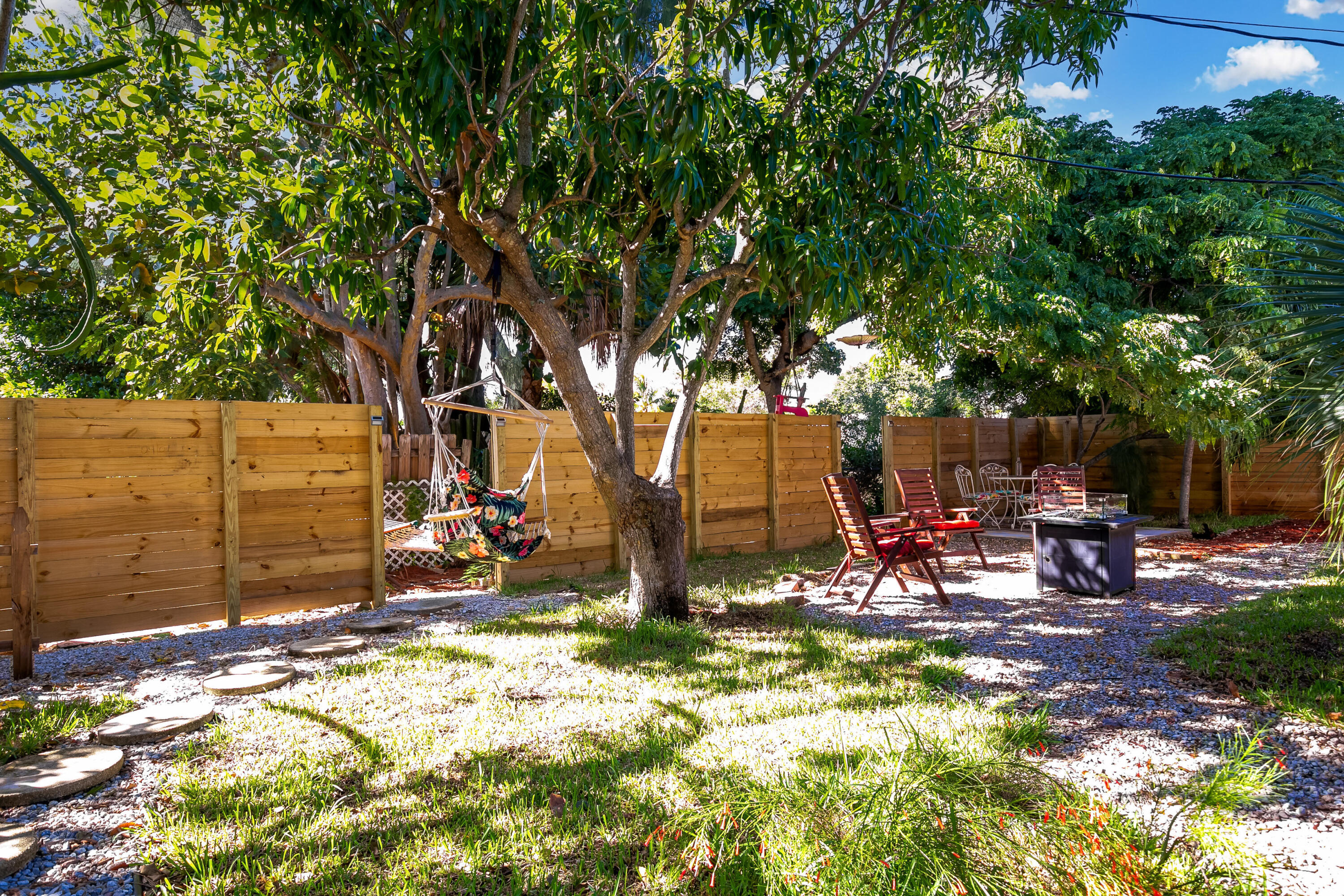 Location, location! This charming 2-bedroom, 2 full bath home is ideally situated in the heart of Lantana, just minutes from beautiful beaches, a public boat ramp, and popular waterfront restaurants.  Set on a spacious, fully fenced lot, the property features lush, shaded  back garden, creating a private outdoor retreat perfect for relaxing or entertaining. Landscaped front garden with two full driveways providing ample parking, with additional space to expand, add a pool, or customize to your needs.  Zoned for multiple dwellings, this property offers excellent flexibility and future potential—whether you're looking to expand the existing home or explore additional living options.  A rare opportunity to enjoy South Florida living with convenience, privacy, and room to grow.