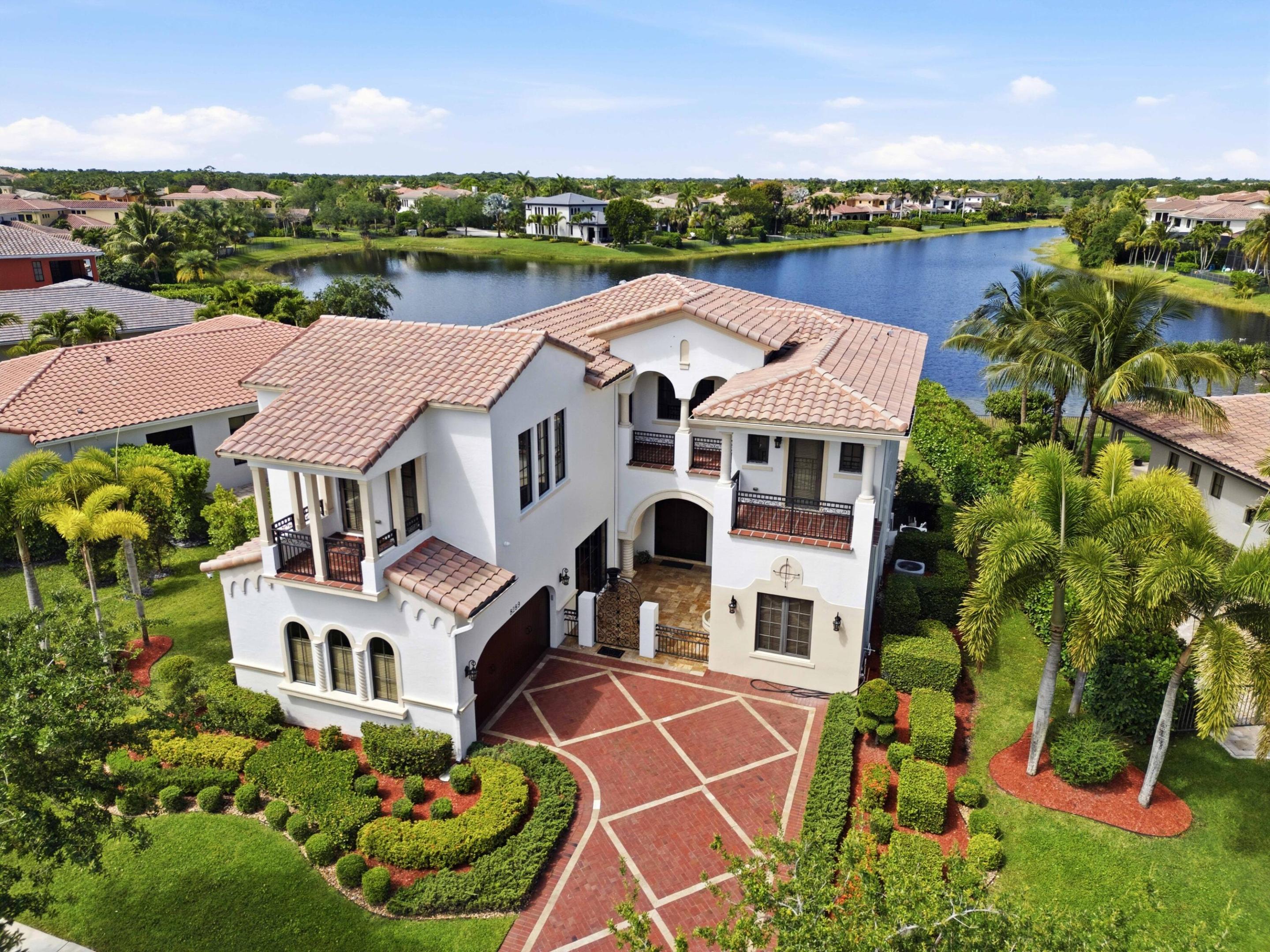 Experience one of the finest waterfront lots in Parkland Golf, showcasing expansive west-facing views and breathtaking sunsets each evening. This exceptional WCI-built home includes a private in-law suite complete with its own entrance, living area, full bathroom, and bedroom—ideal for extended family or older children seeking independence.  With nearly 5,000 square feet of interior living space, the home offers versatility and comfort for a variety of lifestyles. Positioned between two single-story residences, it provides a rare sense of openness where water views take center stage from nearly every room—while still maintaining the privacy you desire.  A truly special property that combines space, views, and functionality—schedule your private showing today.