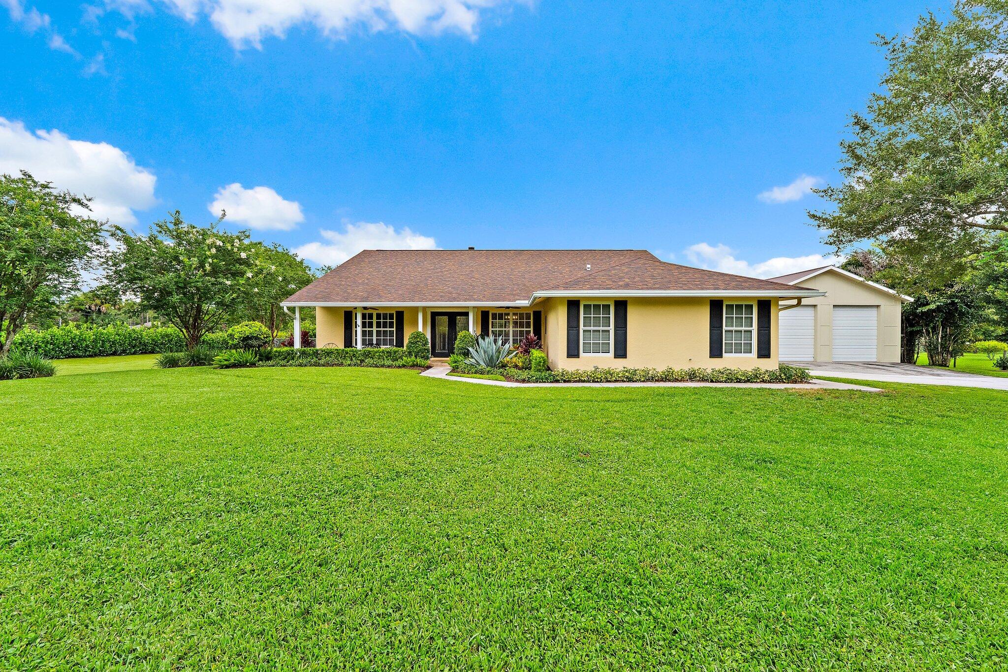 Welcome to 16236 Randolph Siding Road, a beautifully updated, move-in ready home located on one of Jupiter Farms' most desirable paved roads, surrounded by some of the area's finest homes. Offering the perfect blend of privacy, comfort, and convenience, this exceptional property is situated within an A-rated school district and just minutes from shopping, dining, beautiful beaches, I-95, and the Florida Turnpike.  This meticulously maintained 4-bedroom, 2-bath residence features an oversized 2-car garage and a stunning interior that was completely remodeled in 2020. Every detail was thoughtfully updated, creating a bright, modern living space that's truly move-in ready.  The backyard is your own private retreat, highlighted by a resort-style pool and expansive patio installed in 2020—ideal for entertaining family and friends or simply relaxing in your own tropical oasis. Beautiful landscaping and mature trees create a peaceful setting with exceptional curb appeal.  Adding incredible versatility is the detached barn, built in 2021, featuring a loft and dedicated office space—perfect for a home-based business, workshop, studio, gym, or additional storage.  Recent improvements include a new roof (2022), detached barn with loft and office (2021), resort-style pool and patio (2020), complete interior remodel (2020), A/C (2015), water heater (2025), and a whole-house water treatment system (2026).  Combining premium updates, exceptional outdoor living, and an outstanding Jupiter Farms location on a sought-after paved road, this is a rare opportunity to own a truly turnkey home in one of Palm Beach County's most desirable communities.