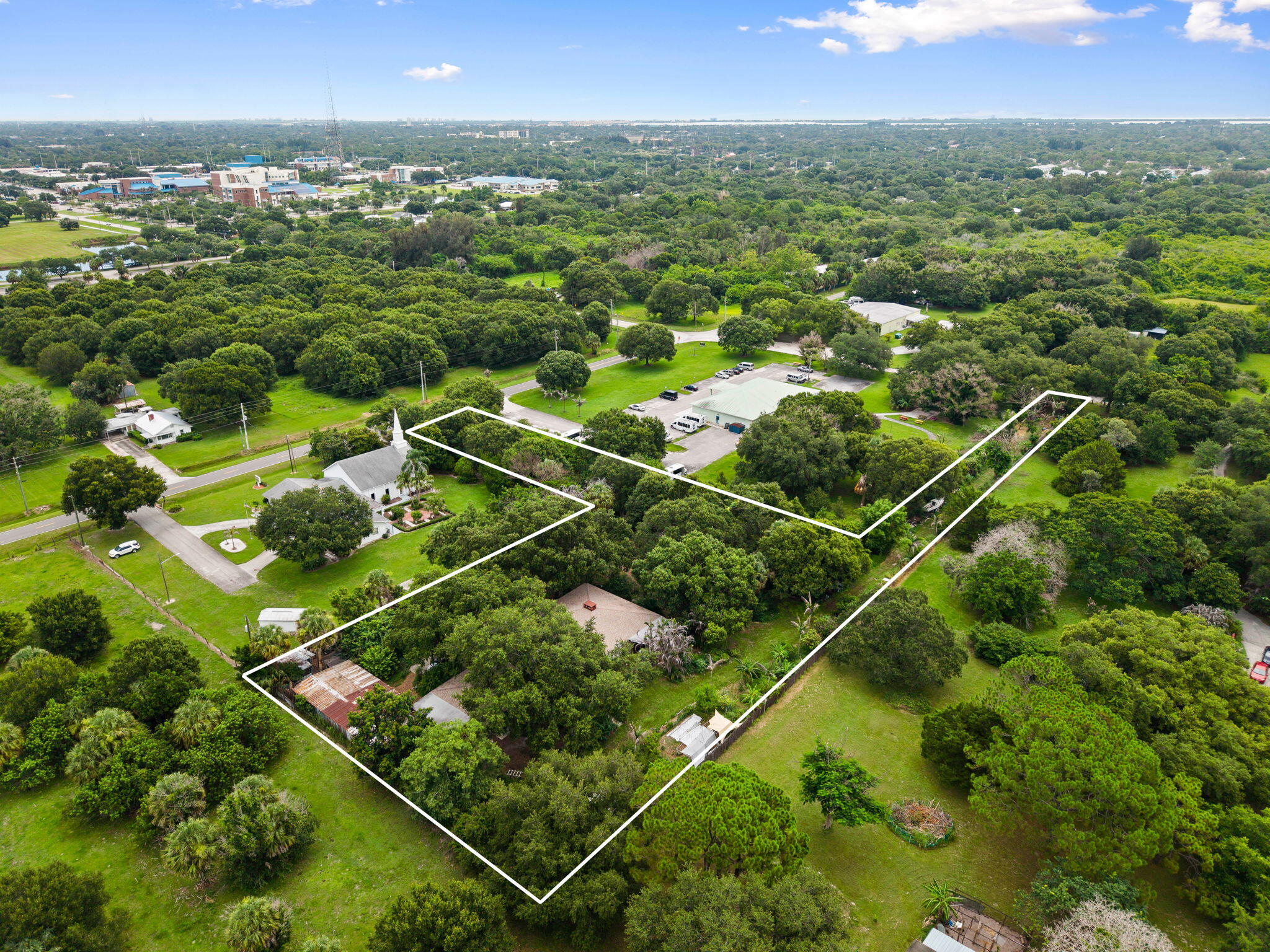 A truly one-of-a-kind property where privacy, sustainability, and natural beauty come together in an exceptional setting. Situated on 1.28 private acres, this unique property features a 3-bedroom, 2-bath main home plus a separate 1-bedroom apartment, offering flexibility for guests, extended family, rental income, or a home office.  Conveniently located just minutes from all that Fort Pierce has to offer, this hidden gem feels worlds away, providing the peace and tranquility of a secluded country retreat.  Lovingly maintained by the same family for decades, this remarkable property has evolved into a thriving homestead and certified wildlife habitat. Thoughtful permaculture practices have transformed the landscape into a productive ecosystem, enriching the soil while creating a flourishing