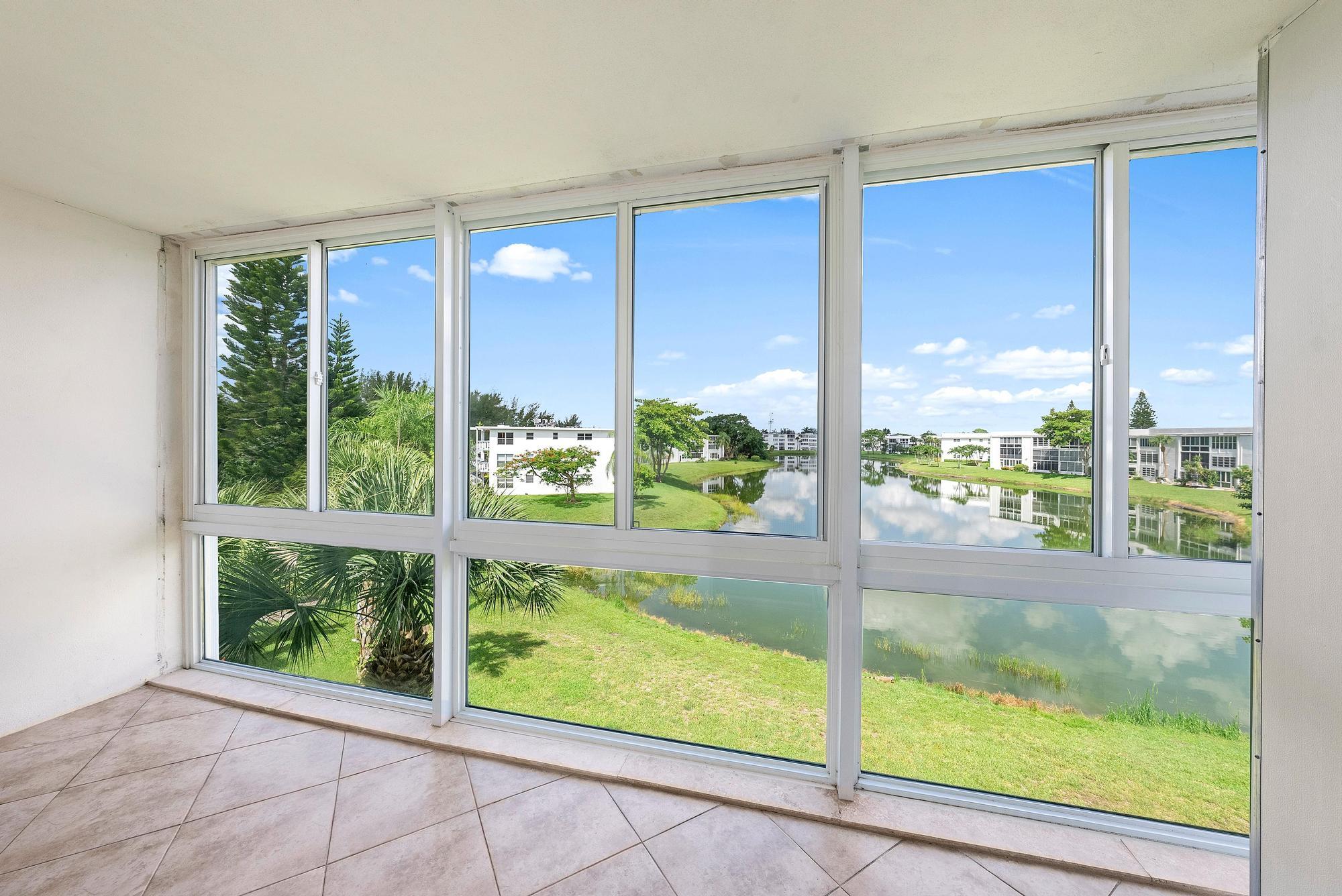 Welcome home to this inviting 3rd floor 2-bedroom, 2-bath condo in Century Village's sought-after Wellington section (55+). Enjoy peaceful water views from many rooms, along with a spacious living and dining area perfect for relaxing or entertaining. The kitchen features a convenient island, while the primary suite offers lovely waterfront views, a private bath, and a walk-in closet. You'll also love the enclosed lanai, impact windows, neutral tile floors, and extra storage. Pet-friendly Wellington E includes elevator access, trash chutes, and two neighborhood pools. Century Village feels like a vacation every day, with a clubhouse, theater, fitness center, pickleball, tennis, multiple heated pools, and 24-hour gated security.