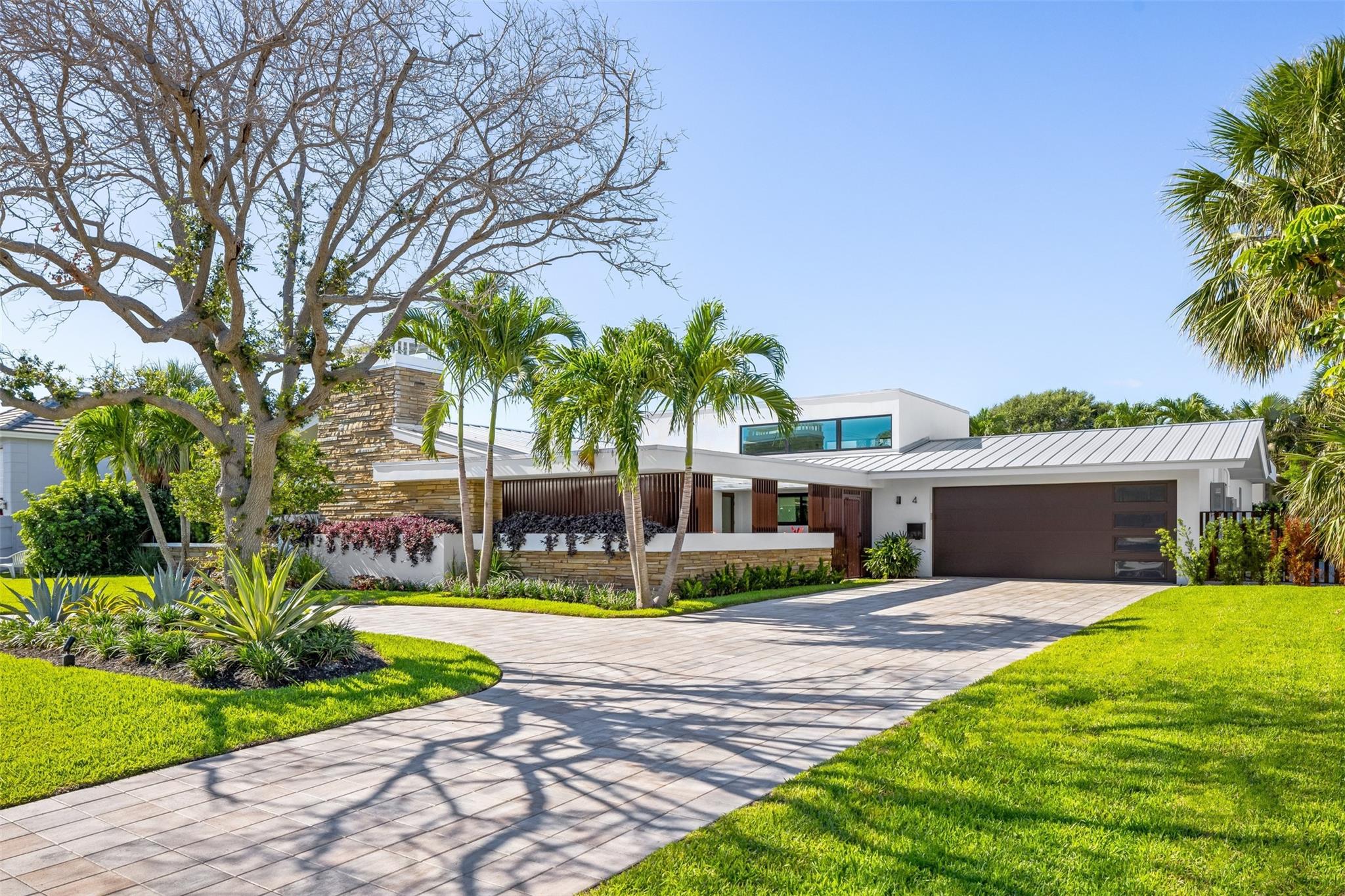 Nestled in the serene community of Sea Ranch Lakes this home offers a harmonious blend of luxury and tranquility. This exquisite property boasts over 4,100 square feet of living space, designed with meticulous attention to detail and the highest quality finishes. Upon entering, you are greeted by an expansive open-concept living area, featuring soaring ceilings and abundant natural light. The gourmet kitchen is a chef’s dream, equipped with top-of-the-line appliances, custom cabinetry, and a large center island perfect for entertaining. Adjacent to the kitchen, the elegant dining area flows seamlessly into the spacious living room, adorned with a cozy fireplace. Step outside to the backyard oasis, where you’ll find a an outdoor kitchen, and a sparkling pool.