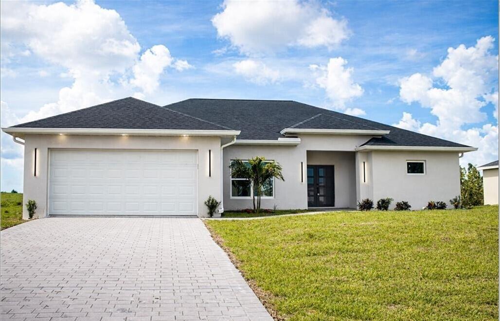 Welcome to this stunning new construction home that perfectly blends modern design with comfort and functionality. Offering a total of 1,774 sqft of living area, this beautifully crafted residence also includes a 422 sqft two-car garage, a 79 sqft covered entry, and a 105 sqft covered lanai—ideal for enjoying Florida living year-round. This spacious home features 4 bedrooms and 2 bathrooms, thoughtfully designed for both style and practicality. The master suite boasts a sleek, fully tiled walk-in shower with elegant glass doors, creating a spa-like retreat. The second bathroom includes a bathtub with tiled walls, perfect for relaxation or family convenience. Throughout the home, you'll find durable tile flooring and impeccable modern finishes.  The 5½-inch contemporary baseboards add a clean, upscale touch to every room. The open-concept kitchen is the heart of the home, featuring a large quartz island, perfect for entertaining, meal prep, or casual dining. Additional highlights include a dedicated laundry area and a spacious two-car garage. Step in to the covered lanai and enjoy peaceful views of the canal running along the backyard—offering both privacy and a serene natural backdrop. This home is a perfect combination of modern elegance and everyday comfort—ready for you to move in and enjoy.