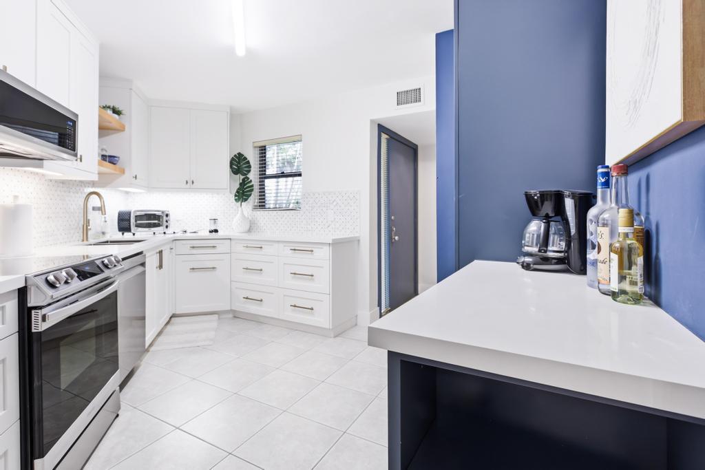 GORGEOUS 2 Bed, 2 Bath in Central Boca Raton within an All Ages, 24/7 manned-gated comm. Features include a Custom Designed Kitchen; Quartz Countertops, Stunning Backsplash, All New Appliances, Pull-out & Soft-close drawers & tons of storage!  IMPACT WINDOWS; Stacking multi-slide doors that bring natural light to every room. Freshly Painted & NO POPCORN CEILINGS! Enjoy peaceful garden views from expansive screened patio.  Short walk from your front door to your Private CARPORT! ORIGINAL OWNERS have kept this property Immaculate! Tennis/pickleball, saunas & 4 comm. pools. Maint. fees incl. INTERNET, Cable, Bldg Ins, Landscaping, Water & manned-gated.  A-rated schools: Verde, Boca Middle & HS. Close to restaurants, shopping, mall, beaches, 95 & FL Tpke.  NO leasing 3 yrs