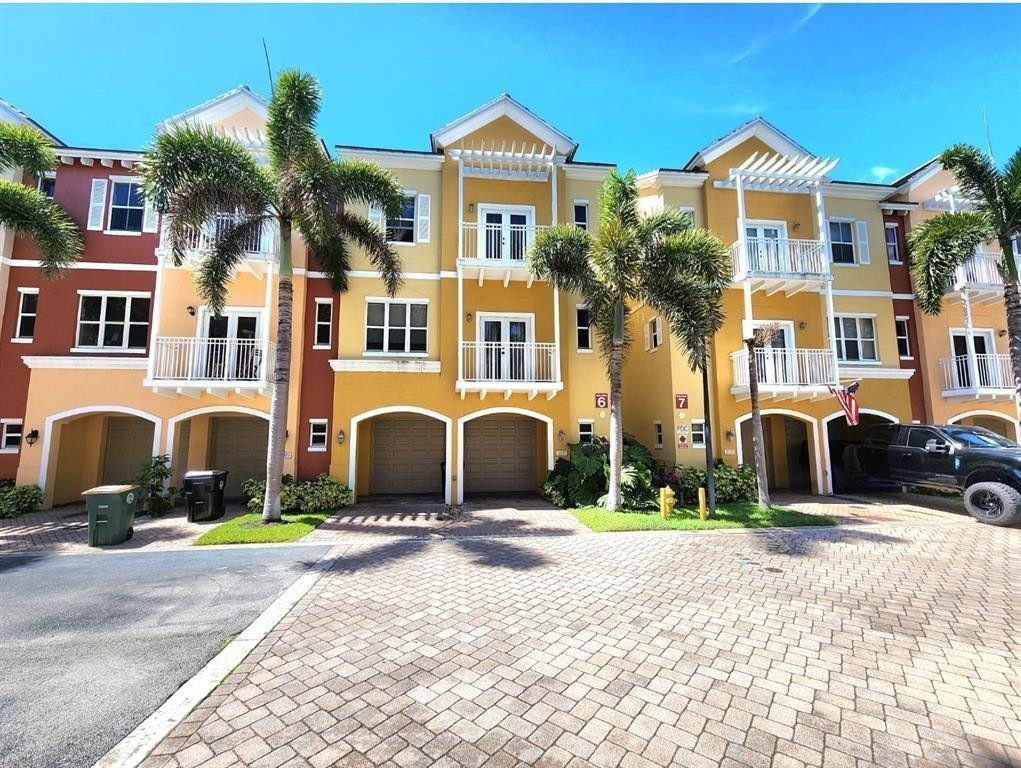 Discover this bright end-unit home, enhanced by extra side windows, in an ideal location just minutes from the beach, Lighthouse Point Yacht Club, Port 32 Marinas, and a variety of shops and restaurants. It features newer stainless steel appliances, two private master suites, and spacious living areas with balconies on multiple levels—perfect for enjoying the coastal breeze. Enjoy peace of mind with impact windows and doors throughout, plus plenty of parking with a two-car garage, driveway, and ample guest spaces. The heated community pool and hot tub are conveniently located just across the street. Monthly maintenance covers exterior insurance, roof, cable, internet, lawn and landscaping, and the gated security entrance.Don't miss your chance to call this beautiful home yours!