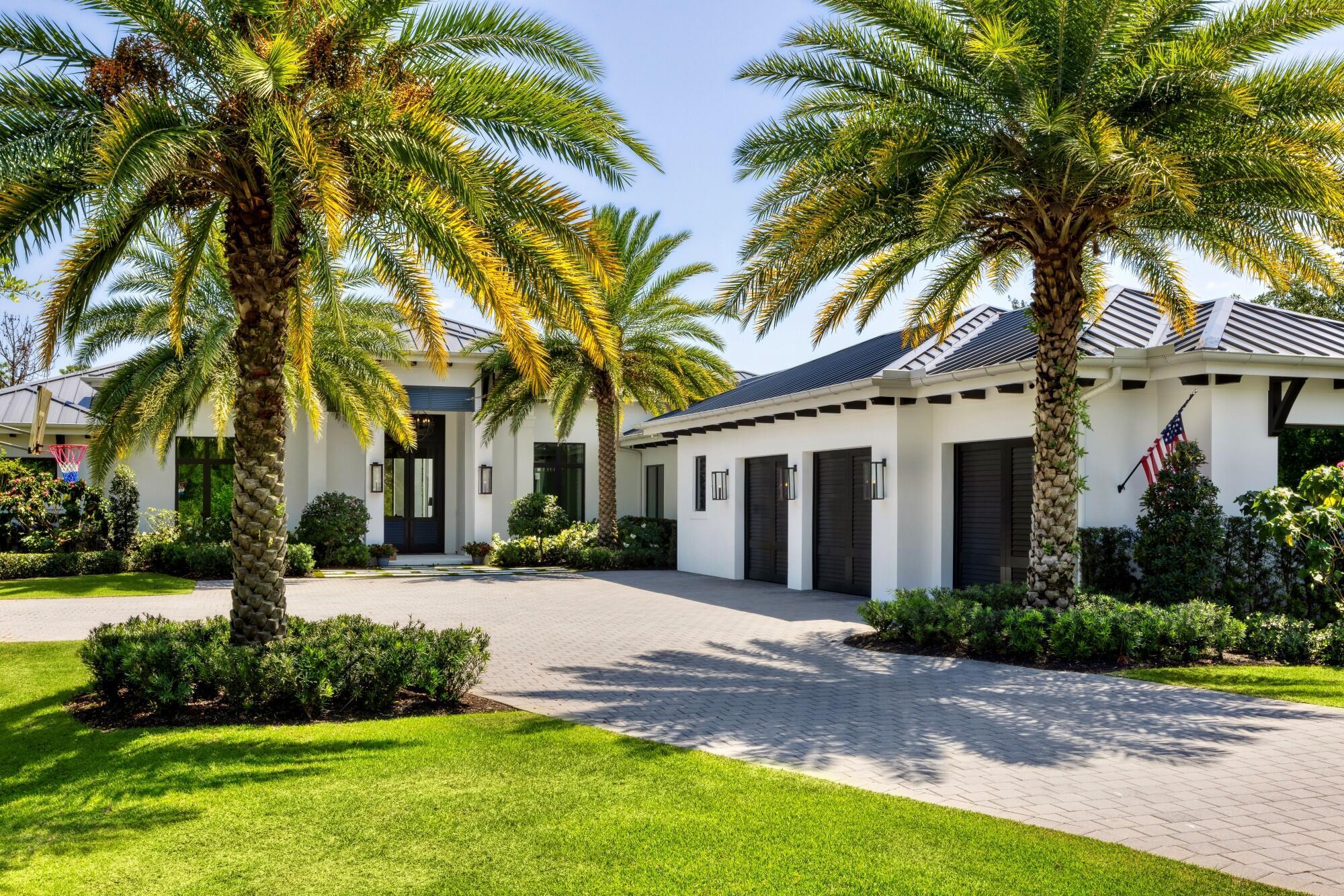 Nestled on a sprawling 1-acre lot in the gated enclave of Hidden Bridge in Jupiter, this magnificent home offers luxury, privacy, and impeccable craftsmanship. Built in 2020 by the renowned Willoughby Construction, no detail was overlooked in creating this exceptional residence. Spanning over 5,000 square feet of refined living space, this home features four spacious bedrooms, each with its own en-suite bathroom, ensuring comfort and privacy for family and guests alike. Additionally, the property includes two elegant half baths, a dedicated office for remote work or quiet study, and a three-car garage designed for both convenience and style. The heart of the home is a stunning open concept living area, where natural light floods through expansive windows, highlighting high-end finishes and thoughtful architectural details. The chef's kitchen, equipped with top-of-the-line appliances and custom cabinetry, flows seamlessly into both formal and casual dining spaces, perfect for entertaining. Step outside to your private oasis: a custom-designed resort-style pool surrounded by lush landscaping, creating a serene and inviting atmosphere. This outdoor space, complete with a covered patio and ample lounging areas, is ideal for both relaxation and hosting gatherings. Hidden Bridge is a unique community with just 16 custom-built estates, offering residents a rare combination of tranquility and exclusivity. Large lots and mature landscaping enhance the sense of privacy, making it one of South Florida's best-kept secrets. Welcome to 7926 SE Hidden Bridge Courtwhere luxury living meets peaceful seclusion in the heart of Jupiter.