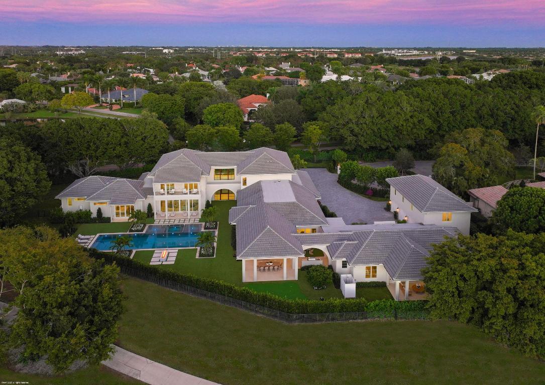 A newly constructed estate of rare distinction, this exceptional compound is set on over one acre in the heart of Palm Beach Polo. Designed for grand-scale entertaining and everyday luxury, the main residence offers five generously appointed bedrooms along with a club room, family/game room, dedicated exercise room, and a private spa complete with sauna and steam room. At the heart of the home, an incredible open-concept kitchen flows seamlessly into the great room and dining area, all overlooking the resort-style pool and expansive covered loggia creating a perfect indoor-outdoor lifestyle. Complementing the main residence is a separate two-bedroom guest house, ideal for hosting. An additional one-bedroom apartment above the garage offers another layer of privacy and flexibility. The outdoor amenities rival those of a private resort, including a swimming pool with spa and sun decks, fire pit, putting green and a fully equipped outdoor kitchen. A 5.5-car garage completes this extraordinary offering. Truly the ultimate estate compound, this one-of-a-kind property delivers unparalleled luxury, space and privacy within Palm Beach Polo.