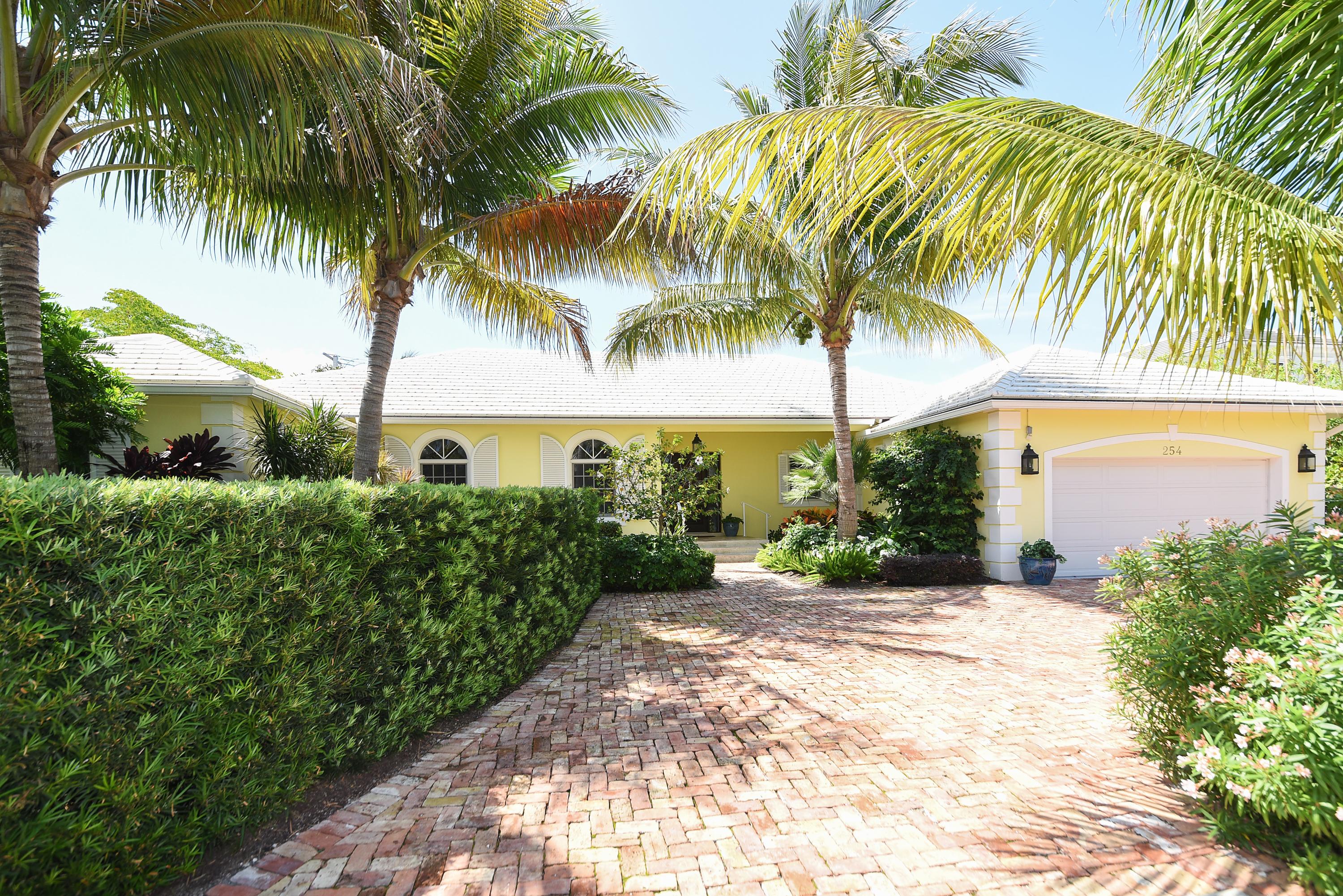 Popular PB north end beach access comes with this one story home on a 13,490 SF. Brand new wood burning fireplace in the living room, two master suites plus 2 en-suite bedrooms, high ceilings, all impact windows/doors, eat-in kitchen, formal living & dining rooms, formal entry leads to open view of the covered loggia, 34x20 heated pool and spacious beautifully landscaped yard.  
Easy access to the ocean and the lake trail, and across the street from the Town's Arboretum.