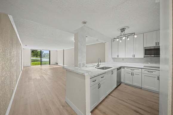 Beautifully Renovated/Updated 1st-Flr, 2-Br, 2-Ba Condo, located in the highly sought-after, amenity-packed Lakes of Delray! This Large Exquisite Unit offers a Split-Bedroom Floor Plan for comfort & privacy, Newly-Renovated Eat-In-Kitchen, New Laminate Flooring throughout, Large Laundry/Storage Rm & an Expansive Living Room w/Sliding Glass Doors opening to a Breathtaking Lake View!  This Popular Gated Community boasts 3 Pools, XL Hot Tub, Separate Men & Women Saunas, Poolside BBQ Area, Clubhouse, Tennis, Basketball, Pickleball, Shuffle Board, Fitness Ctr, Game Rms, Library, Multi-Purpose Ballroom, Clubs, Shows & Activities Galore!  Minutes to Downtown, Beaches, Shopping, Dining, Entertainment & More! Get ready to fall in love with this Exceptional Home! Make an appt to see it TODAY! Renovated and freshly painted walls!