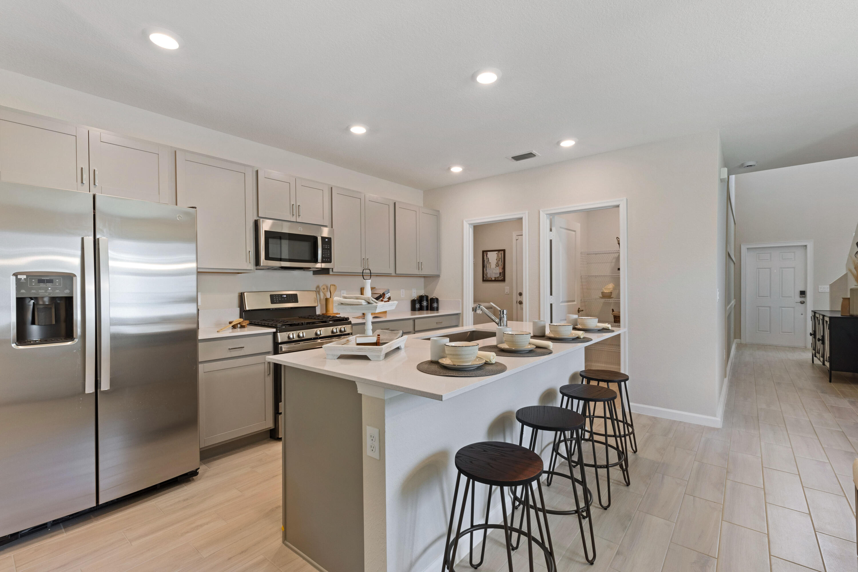 This stunning two-story, 5-bedroom, 2.5-bath home offers an open-concept layout, seamlessly connecting the kitchen, dining, and living areas for effortless transitions. The first-floor owner's suite provides added privacy, while the second floor features 4 additional bedrooms and a cozy loft. Enjoy outdoor leisure on the ready-to-use patio. The home includes a convenient two-bay garage, stainless steel appliances, a gas range, quartz countertops, upgraded light fixtures, and a Ring doorbell system. **Neighborhood includes a beautiful clubhouse, fitness center, community pool, pickleball courts, playground, and more! This is an incredible opportunity to make this beautiful house in this lovely neighborhood your home!** Photos are for illustrative purposes only.