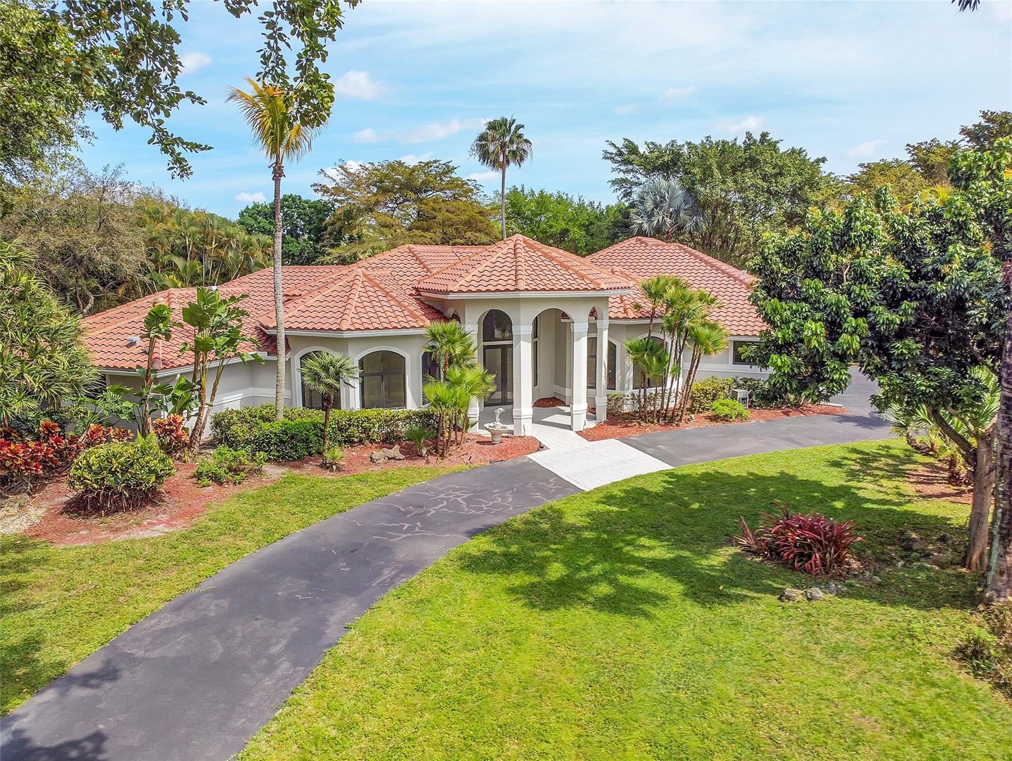 Enjoy refined living in this exquisite 5-bed, 4-bath estate on an expansive 45k sqft lot in the exclusive gated community of Whispering Woods. Completely remodeled with impeccable attention to detail, this stunning home seamlessly blends elegance, comfort, and modern sophistication. Generous living spaces flow effortlessly to a spacious outdoor entertainment area, ideal for hosting upscale gatherings or enjoying serene, private evenings. Perfectly located near premier restaurants, upscale shopping, vibrant nightlife, and more, with convenient access to the Sawgrass Expy and Turnpike. This is a rare opportunity to own a truly gorgeous, move-in-ready home on an oversized lot in one of the area’s most desirable neighborhoods. Impact windows & doors throughout. A must-see luxury residence.