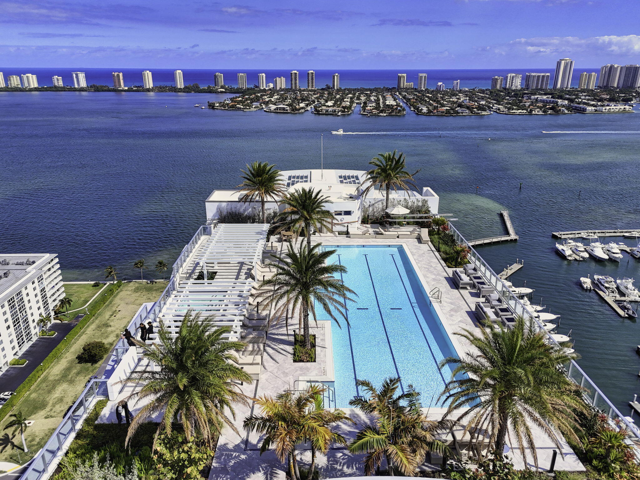 Welcome to Nautilus 220—where brand-new waterfront luxury meets an elevated, amenity-rich coastal lifestyle. Perfectly positioned on the highly sought-after 6th-floor amenity level, this exceptional 2-bedroom, 2.5-bath residence offers a rare and coveted advantage: immediate access to the building's premier resort-style offerings, just steps from your door.  Designed to impress, this residence features dramatic 12.5-foot ceilings—among the highest in the entire building—creating a striking sense of volume, light, and architectural elegance rarely found in condominium living. Expansive floor-to-ceiling impact glass floods the interiors with natural light while showcasing sweeping views of the marina and city skyline.  The designer chef's kitchen is both sophisticated and functional, appointed with sleek Quartz countertops, premium Miele appliances, and refined modern cabinetry—perfect for entertaining or everyday luxury. Smart-home ready technology enhances convenience, seamlessly blending innovation with style.  Step out onto your expansive private terrace—an ideal extension of your living space—perfect for morning coffee, sunset cocktails, or relaxed outdoor entertaining with tranquil Lake Park vistas as your backdrop.  What truly sets this residence apart is its unparalleled 6th-floor location, placing you directly within Nautilus 220's extraordinary amenity level. Enjoy effortless access to a resort-style pool and spa, private cabanas, yoga deck, summer kitchen and pavilion, gazebo lounge with fire pit, and putting green—all just moments away. Inside, indulge in the wellness plaza featuring a state-of-the-art fitness center, spin studio, yoga rooms, steam, and sauna. Nautilus 220 delivers a full-service luxury lifestyle with valet and secure garage parking, a grand attended lobby, and 24-hour security. Residents also enjoy exclusive dining by celebrity chef David Burke at SeaHawk Prime, along with exceptional entertainment amenities including a golf and sports simulator, private bowling lounge with bar, rooftop infinity pool and spa, and an observation deck with breathtaking Intracoastal and Atlantic Ocean views.   As an exceptional added value, the owner will consider paying the remaining balance of 2026 condominium fees for the buyer—an exclusive incentive that enhances both convenience and investment appeal.  Be the very first to call this stunning waterfront residence home, where soaring ceilings, premier 6th-floor access, and world-class amenities come together to create a truly unmatched living experience.