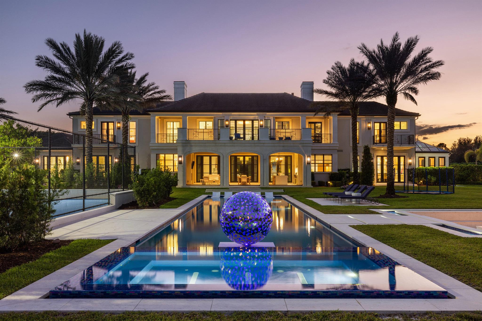 La Maison Blanche — The Pinnacle of Lakefront Luxury; Stone Creek Ranch, Delray Beach

Welcome to La Maison Blanche, a rare architectural triumph that redefines estate living in Stone Creek Ranch — an ultra-private enclave of only 37 grand compounds spread across nearly 200 verdant acres in the heart of Palm Beach County. Quietly known as home to titans of industry, global entertainers, and legacy families, this community represents the pinnacle of South Florida luxury living — where privacy, prestige, and power harmonize behind guarded gates.
This 16,000+ SF east-facing lakefront estate is a masterstroke of design and detail, brought to life by Ellemar Builders, the celebrated visionaries at Affiniti Architects, and curated by internationally renowned Marc Michaels -> Interior Design. The result is a seamless blend of timeless French-inspired elegance and modern sophistication, executed at a level reserved for the world's most discerning clientele.
Nestled amidst towering palms, manicured gardens, and sweeping water views, this compound offers an unrivaled lifestyle both indoors and out. The exterior is highlighted by a dramatic 76-foot heated saltwater pool featuring a sculptural installation by acclaimed artist David Harber, oversized spa, sunken fire lounge for 20+ guests, in-ground trampoline, full-size tennis and basketball courts, and a cabana house complete with bath, storage, and a state-of-the-art Wolf summer kitchen designed for seamless entertaining.

Step inside and indulge in craftsmanship without compromise:
* A chef's kitchen with custom Edgarsman cabinetry, Miele appliances, and sunlit breakfast nook
* A scullery kitchen featured in Martha Stewart Magazine, complete with a Wolf range and wine chiller
* An elegant formal dining room seating 16
* A custom piano conservatory flooded with light
* A plush 18-speaker Dolby theater with cocktail bar
* A full wellness wing with massage room, sauna, and cold plunge

The second-floor primary suite is a sanctuary unto itself, offering a fireplace lounge, dual spa-style bathrooms, boutique-style dressing rooms, and a grand lakeview terrace. Five additional VIP guest suites (three down, two up) ensure ultimate privacy and comfort, along with a dedicated craft studio, second laundry, and hidden built-in storage features throughout the home.
Outfitted with Crestron Smart Home automation, this estate offers fingertip control over lighting, security, sound, and climate creating a fully immersive luxury experience with peace of mind.

La Maison Blanche is not just a home... it is a statement. A rare opportunity to own one of South Florida's most architecturally significant, thoughtfully designed, and impeccably curated luxury estates in a community reserved for the few who expect everything.