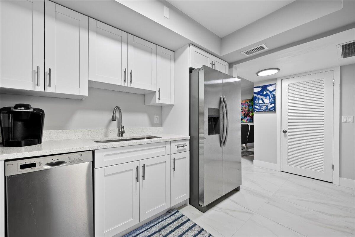 Welcome to easy Florida living in the desirable 55+ Tamberlane community! This beautifully maintained 2-bedroom, 2-bath first-floor corner condominium offers 959 square feet of comfortable living space in a prime Palm Beach Gardens location. Step inside to a bright and inviting floor plan featuring an updated kitchen with white cabinetry, stainless steel appliances, and ample storage. The spacious primary suite includes a private bath and generous closet space, while the second bedroom and full guest bath provide flexibility for visitors or a home office. Enjoy peaceful community surroundings, waterfront views, and resort-style amenities including a clubhouse, pool, shuffleboard, and an active social calendar. Conveniently located just minutes from The Gardens Mall& world-class dining