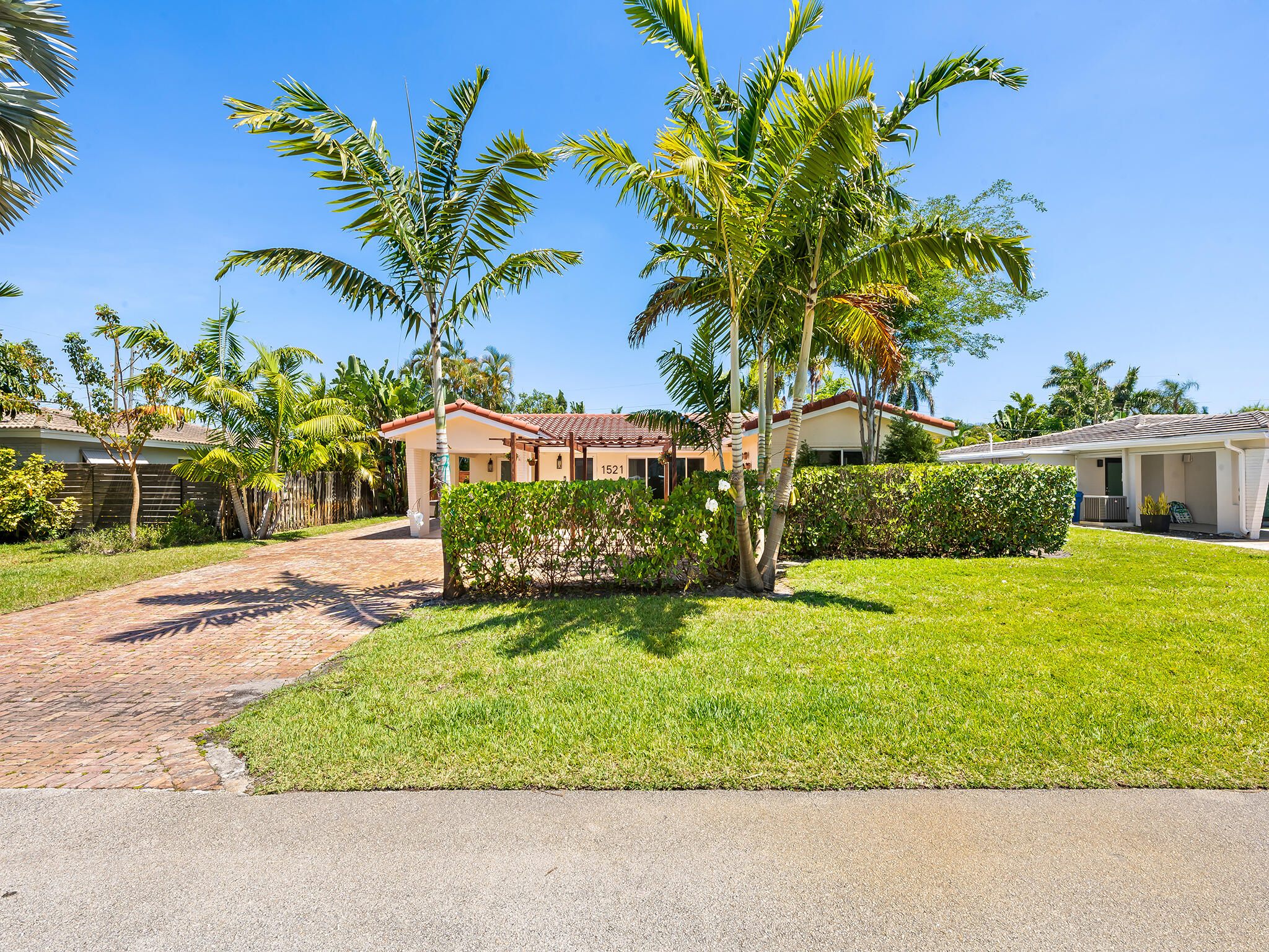 Tastefully updated 3/2 residence on a quiet, walkable street in the sought-after Coral Heights neighborhood. This light-filled home showcases impact-rated hurricane doors and windows, inviting open-concept living/dining area, bright Florida room & tankless water heater. The private serene backyard features an inviting salt water heated pool, hot & cold plunge, covered dining area, & outdoor shower. Lush, mature palms & clusia hedge surround the fully fenced yard, creating a serene sense of privacy all ideally located moments to dining, shopping, and the beach. Completing the home's appeal is a 2016 roof, an expansive Chicago brick driveway providing ample parking, while the residence itself is gracefully set back from the street, offering a sense of space & distinction.