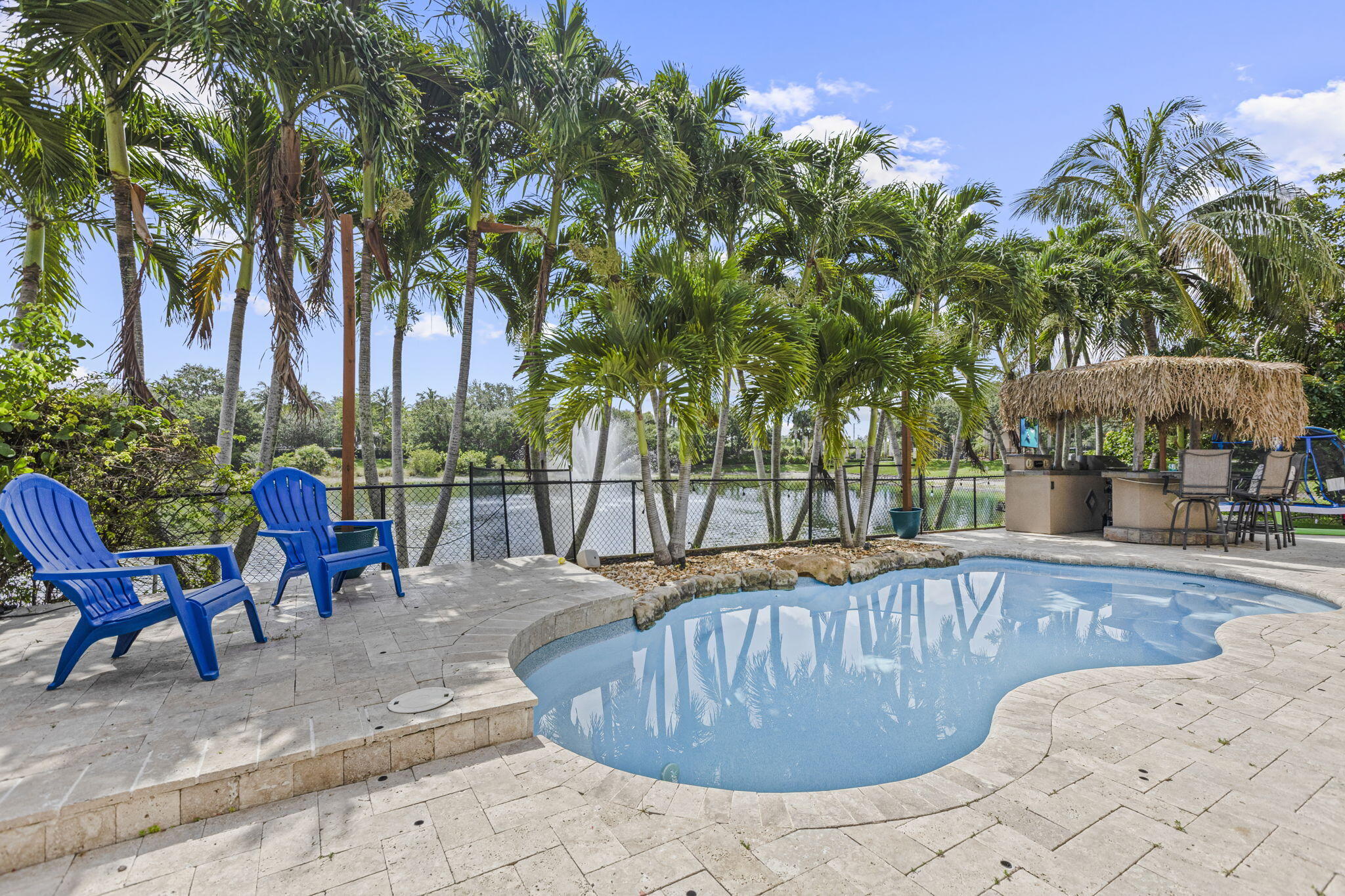 Rarely available and beautifully updated, this exceptional one-story lakefront residence is ideally situated on one of the most desirable streets in the community.  Built in 2006 and situated on a premium homesite among the community's larger residences and lots, this exceptional home seamlessly combines modern updates, timeless style, and effortless Florida living. Offering 4 bedrooms, 3 bathrooms, a 3-car garage, and 2,398 square feet of thoughtfully designed living space, the home welcomes you with an open, light-filled floor plan enhanced by updated flooring throughout. The stunning chef's kitchen was completely renovated by the current owners and serves as the centerpiece of the home, featuring quality finishes, abundant cabinetry, and an ideal layout for entertaining and everyday liv ing. The spacious primary suite is a true retreat, complete with a beautifully renovated spa-inspired bathroom and an oversized custom walk-in closet. A secondary bathroom has also been tastefully updated, adding to the home's move-in-ready appeal. There is also beautiful new porcelain tile flooring throughout the home. Step outside to your private backyard oasis overlooking peaceful lake views. Designed for year-round enjoyment, the outdoor living space features a sparkling pool, covered patio, and charming tiki hut—perfect for entertaining guests or simply relaxing while taking in the tranquil waterfront setting. Additional improvements include a 2018 air conditioning system, a newer tankless water heater, and the peace of mind that comes with a professional home inspection completed in April. The sellers have proactively addressed the vast majority of the inspection items, allowing the next owner to move in with confidence. With an unbeatable combination of a sought-after single-story floor plan, extensive renovations, premium lakefront location, and exceptional condition, 455 Cresta Circle is a rare offering that truly stands out. Priced at $779,000, this is an outstanding opportunity to own one of the community's most desirable homes.  Located within the highly desirable, 24-hour guard-gated community of Terracina, residents enjoy resort-style amenities including a clubhouse, fitness center, swimming pool, tennis courts, playground, and beautifully maintained common areas—all while being just minutes from shopping, dining, major highways, Palm Beach International Airport, and downtown West Palm Beach.