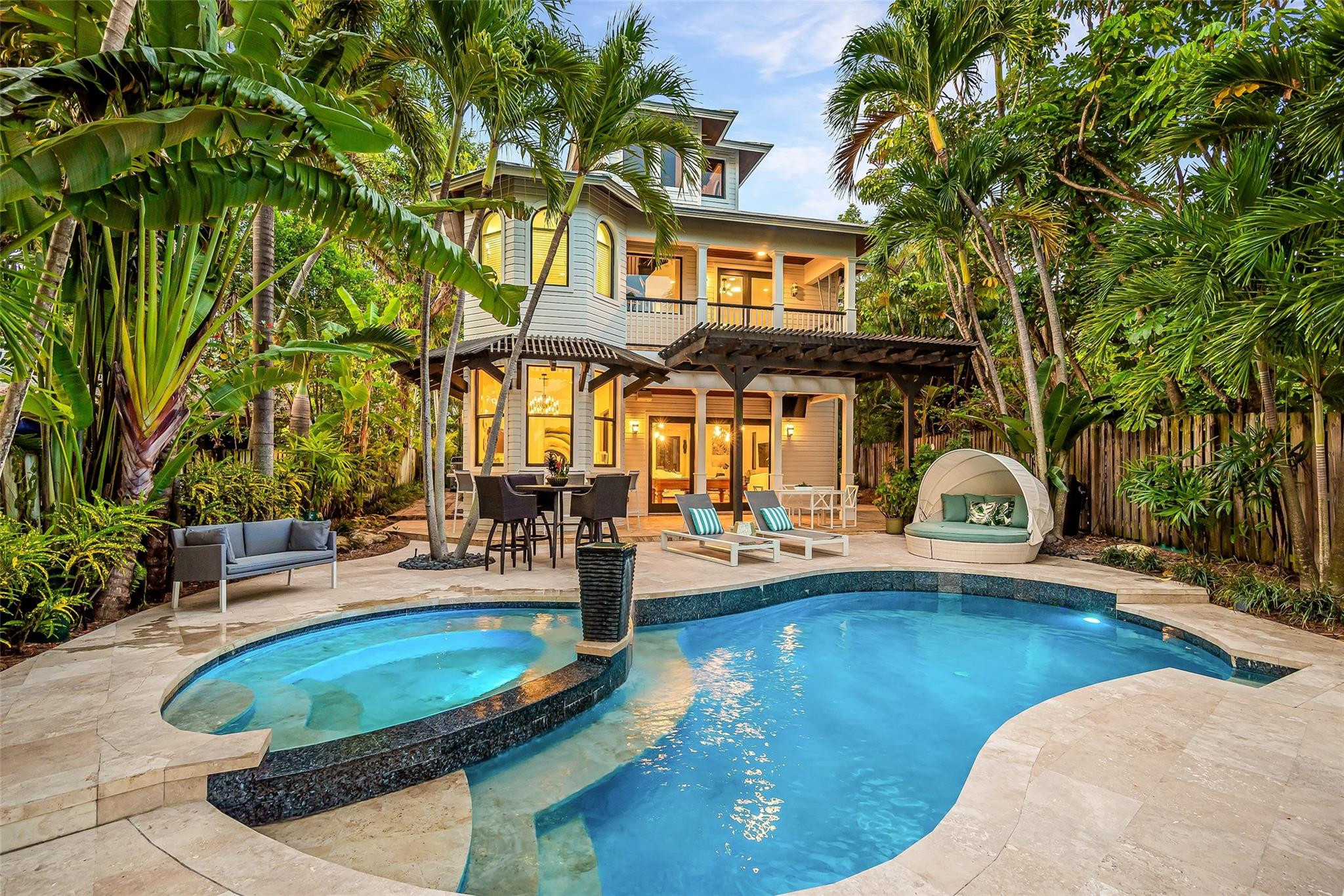 On Middle River in desirable Bayview School District! Timeless architecture at its finest, crowned w/ cupola inviting natural light throughout. Gated estate, surrounded by tropical vegetation & privacy. Concrete dock/slip. Enjoy spectacular sunsets entertaining or relaxing in resort-style pool-spa area w/ its own A/C'd indoor/outdoor cabana bar+kitchen. Chef-ready main kitchen, equipped w/ Sub Zero, 48' Wolfe gas range & quartz countertops. Impressive & spacious master suite w/ river & pool views from sitting area, private covered balcony+loft atop private spiral master staircase. High ceilings, wood burning fire place, heated pool, impact glass+doors. New A/C systems & full house reverse osmosis/remineralization water filtration system yielding water in perfect numbers.