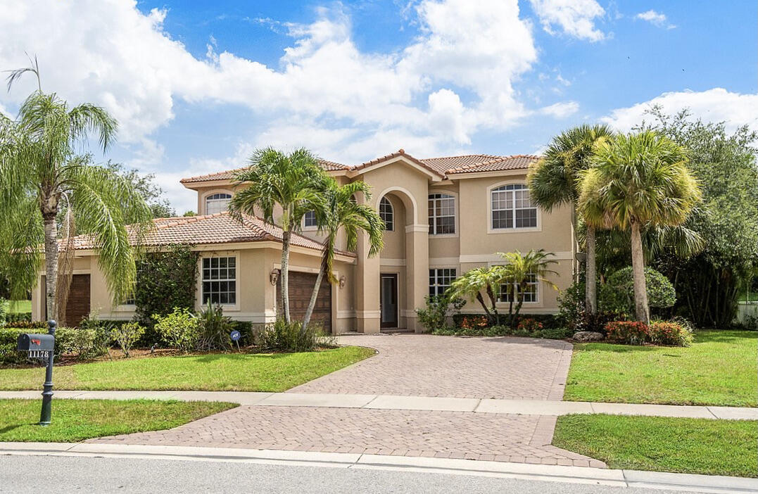 Welcome to this beautifully maintained 5-bedroom, 3-bath pool home situated on an oversized 0.36-acre lot in the highly sought-after Isles at Wellington. Offering over 3,400 sqft of thoughtfully designed living space, this exceptional residence features soaring volume ceilings, abundant natural light, and an open, functional floor plan ideal for both everyday living and entertaining. The gourmet kitchen is a chef's dream, complete with wood cabinetry, double wall ovens, a large center island with seating, a walk-in pantry, and a bright breakfast nook with a charming bay window overlooking the backyard. The spacious family room flows seamlessly to the outdoor living area, while a first-floor room provides the perfect space  for a home office, playroom, or guest bedroom. Retreat to the generous primary suite featuring a relaxing sitting area, expansive walk-in closets, and a luxurious ensuite bath designed for comfort and relaxation. Step outside to your private tropical oasis featuring an oversized pool with decorative fountains, an expansive patio, and a lush backyard with no rear neighbors—perfect for entertaining or enjoying peaceful Florida living. Located within the gated Isles at Wellington, residents enjoy resort-style amenities including a clubhouse, fitness center, pool, tennis and pickleball courts, basketball courts, playgrounds, and scenic walking paths. Conveniently located near Wellington's world-renowned equestrian venues, A-rated schools, shopping, dining, parks, and major highways, this home offers the perfect combination of luxury, privacy, and convenience.
